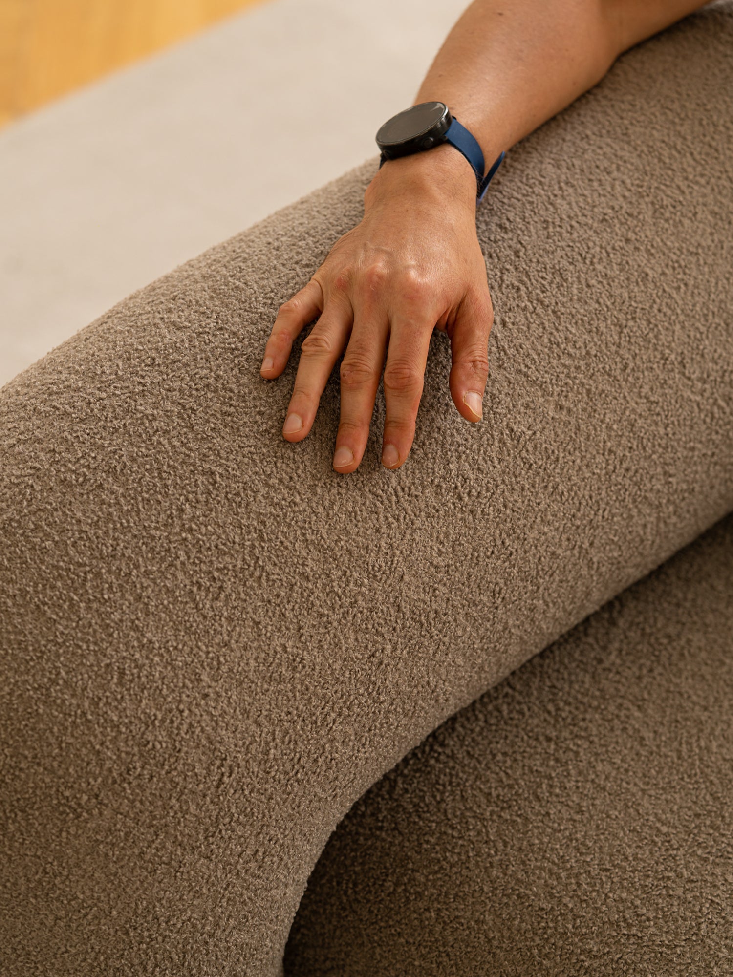 ARTU Moss 2400 Sofa, an organic modern sofa upholstered in a rich, earthy taupe boucle-style fabric with a deep, inviting looped pile texture, showcasing a plush, rounded armrest or backrest detail. This contemporary textured sofa is perfect for creating cozy minimalist living room spaces or adding warm, tactile comfort to any modern lounge.
