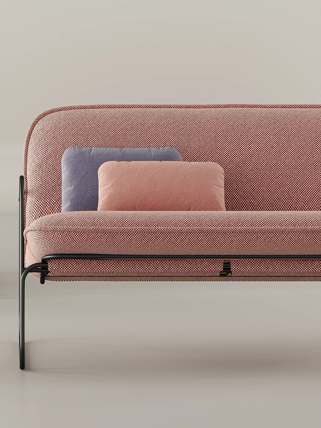 ARTU Tuttu Monteur Sofa, a modern minimalist 2-seater sofa featuring a gently curved backrest and plush seat upholstered in a textured reddish-pink woven fabric with a fine flecked pattern, supported by a sleek matte black metal frame. This contemporary sofa includes two rectangular accent pillows in contrasting dusty blue and soft pink. It's an ideal compact living room sofa or stylish apartment seating for modern, design-conscious interiors.