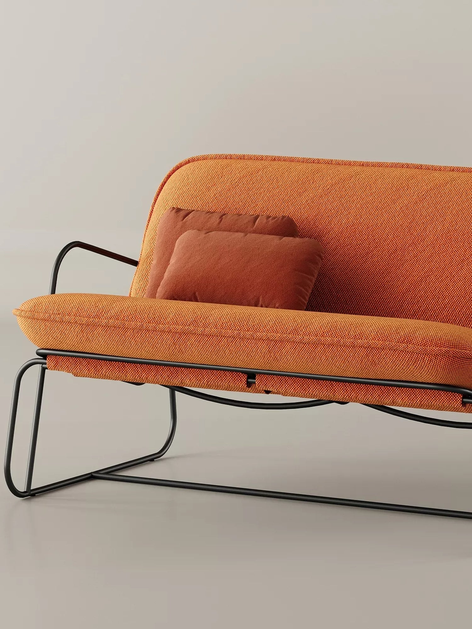 ARTU Tuttu Monteur Sofa, a modern minimalist 2-seater sofa featuring vibrant orange woven fabric upholstery and a sleek matte black tubular metal frame with integrated armrests. It includes two coordinating burnt orange throw pillows for added comfort and style. Perfect as a contemporary compact sofa for small living rooms or stylish lounge areas.