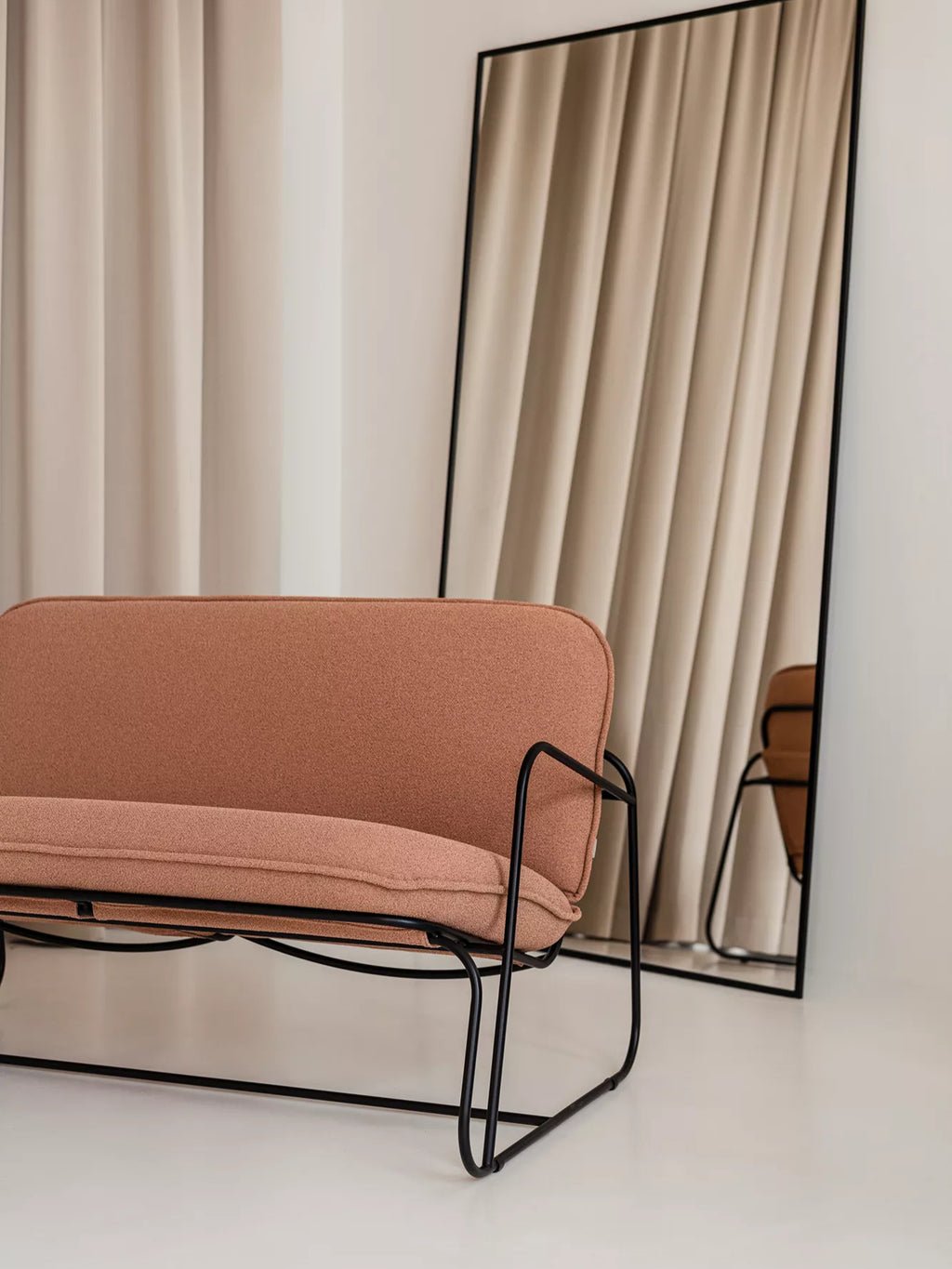 ARTU Tuttu Monteur Sofa, a modern minimalist 2-seater sofa featuring a warm terracotta-toned textured woven fabric upholstery with plush cushions and a distinctive matte black metal frame. Its sleek, curved industrial-chic design offers a compact seating solution with clean lines. Ideal for contemporary living rooms, small apartments, or stylish entryways seeking a touch of organic modern design.