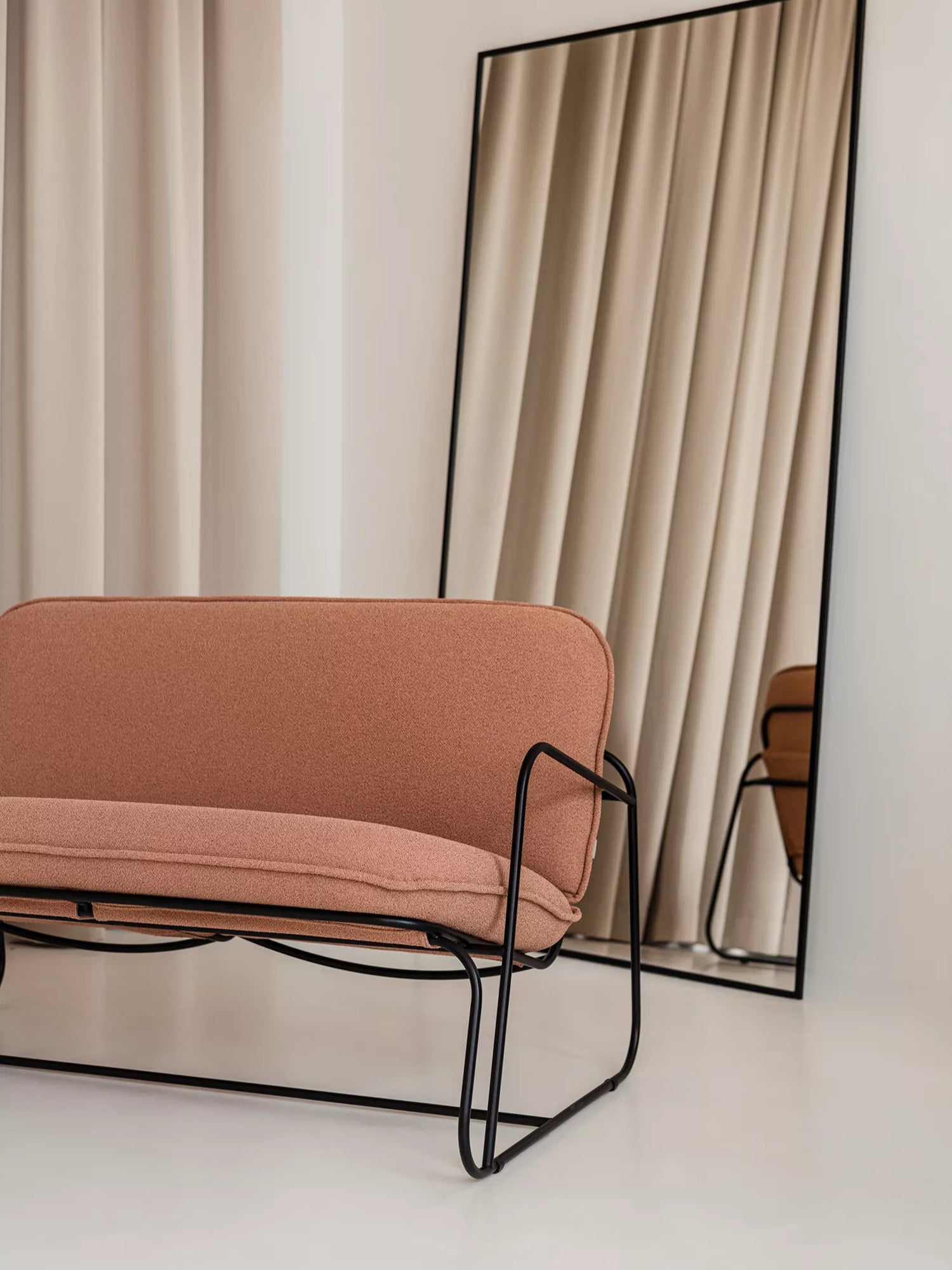 ARTU Tuttu Monteur Sofa, a modern minimalist 2-seater sofa featuring a warm terracotta-toned textured woven fabric upholstery with plush cushions and a distinctive matte black metal frame. Its sleek, curved industrial-chic design offers a compact seating solution with clean lines. Ideal for contemporary living rooms, small apartments, or stylish entryways seeking a touch of organic modern design.