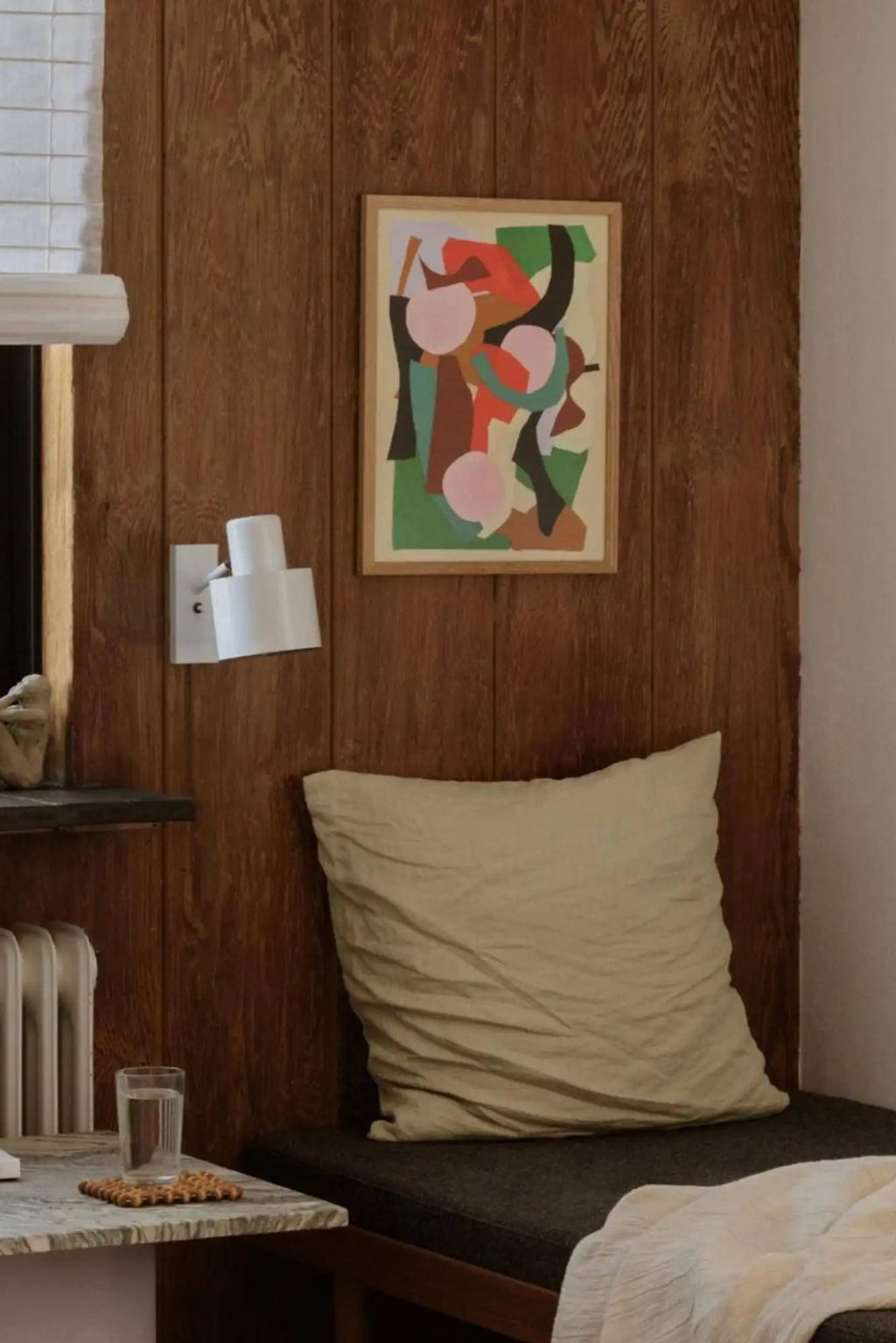 The Poster Club Botanic, a vibrant multi-colored abstract art print featuring organic shapes in a playful composition of pink, red-orange, teal green, and earthy brown tones on a light cream background. This contemporary wall art is elegantly presented in a minimalist natural oak wood frame. Perfect as a focal point for modern living room decor, mid-century modern interiors, or a colorful addition to a gallery wall.