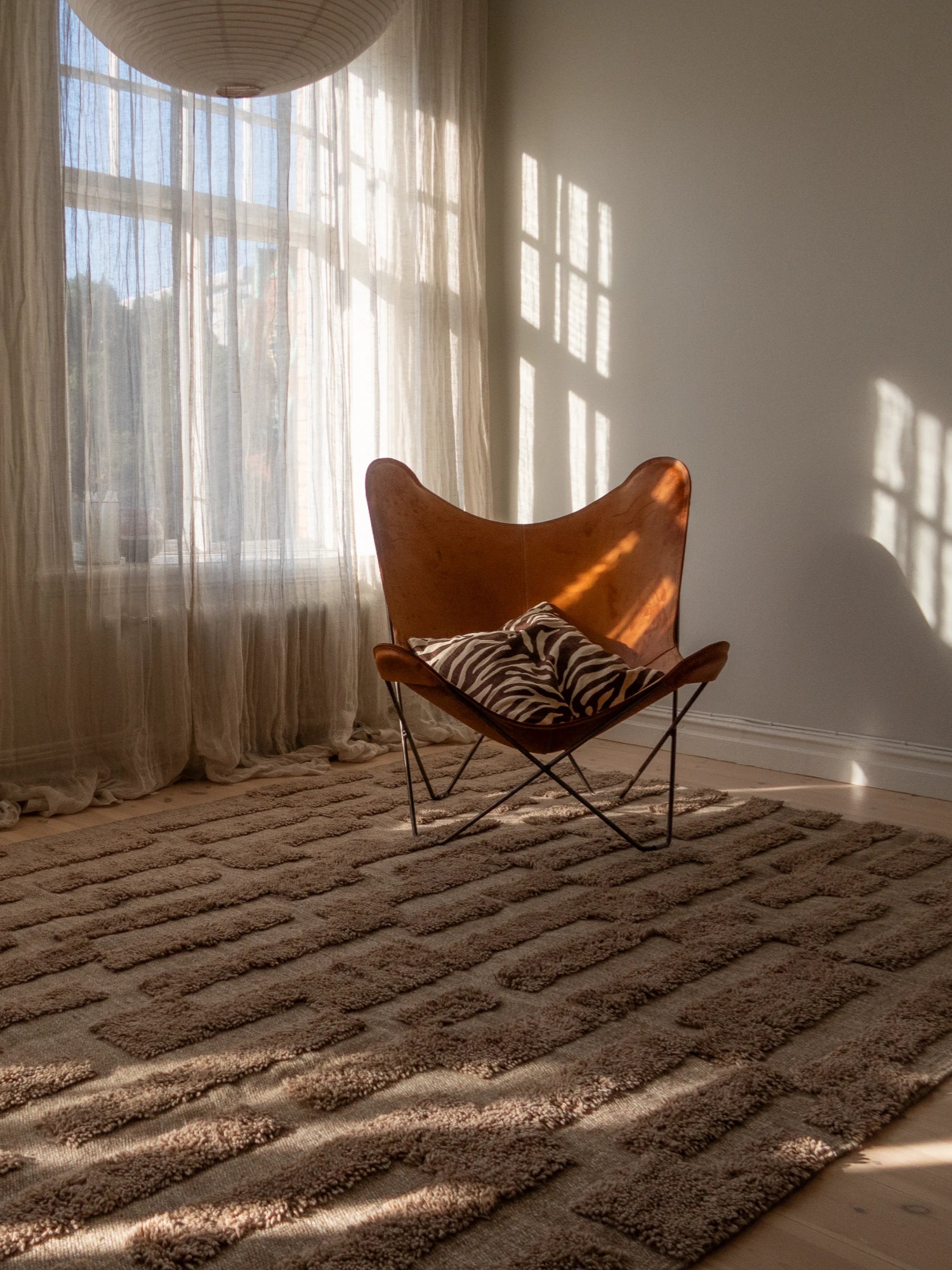 Tinted Objects Bielke Wool Rug, a natural undyed wool area rug featuring a plush, textured geometric pattern of raised shaggy rectangular blocks in warm beige and taupe tones over a flat-weave base. This cozy, minimalist rug is perfect for Scandinavian living rooms, organic modern bedrooms, or contemporary spaces seeking warmth and texture.