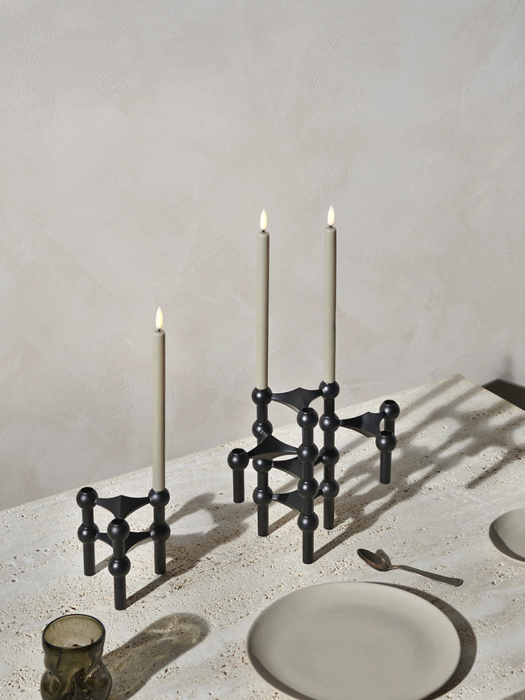 Stoff Nagel LED Candles - Set of 2, a pair of modern minimalist light grey taper candles featuring realistic flickering LED flames, designed to perfectly fit modular candle holders. These battery-operated flameless candles offer a safe, warm glow, ideal for creating an inviting ambiance on a dining table centerpiece or in contemporary living room decor.