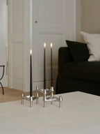 The brushed chrome BMF Candle Holder as a stylish centerpiece for any modern home decor.