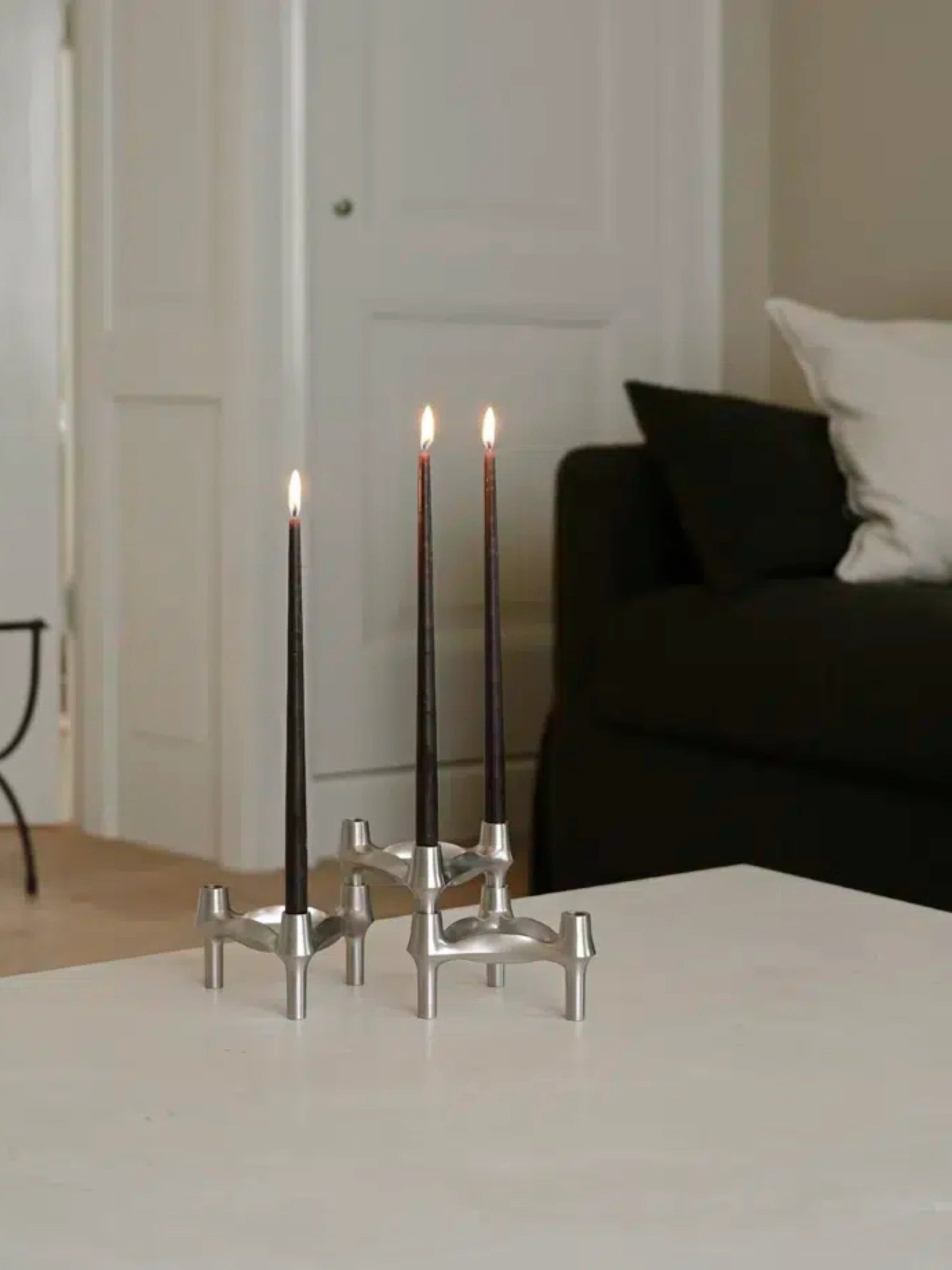 The brushed chrome BMF Candle Holder as a stylish centerpiece for any modern home decor.