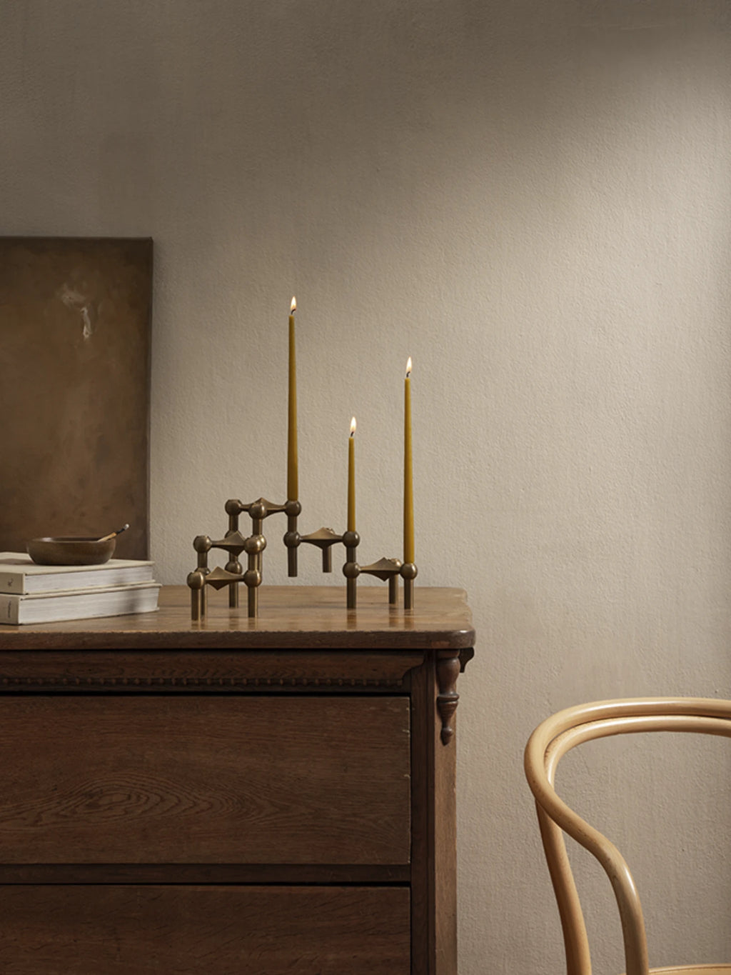 Stoff Nagel Taper Candles - Set of 6, a collection of long, slender candles in a warm mustard yellow hue, designed to perfectly complement the iconic modular Stoff Nagel candle holders. These elegant taper candles provide a soft, inviting glow, ideal for creating a cozy ambiance in modern minimalist, mid-century modern, or contemporary living spaces.