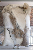 Fur rug shaped like a horse head with a brick wall background