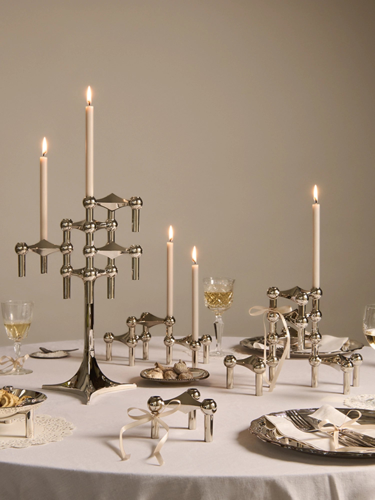 Stoff Nagel Beeswax Candles - Set of 8, a collection of elegant cream beeswax taper candles featuring a smooth finish and a long, slender cylindrical form. These ivory dinner candles offer a warm, inviting glow, perfect for creating an ambient atmosphere. Ideal for pairing with iconic Stoff Nagel candle holders or as classic decorative candles for dining tables and sophisticated home decor.
