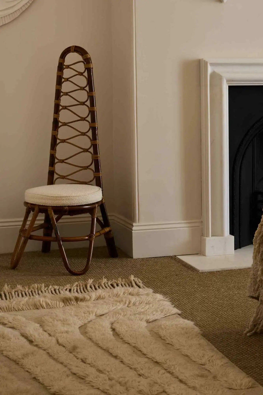 Cappelen Dimyr Colonnade No.04 Rug, a luxurious hand-knotted wool area rug featuring a plush, shaggy texture in a natural undyed cream color. Its organic wavy pattern creates a soft, inviting aesthetic, complemented by delicate fringed edges. Ideal for adding warmth and sophisticated texture to Scandinavian living rooms, organic modern bedrooms, or minimalist spaces.