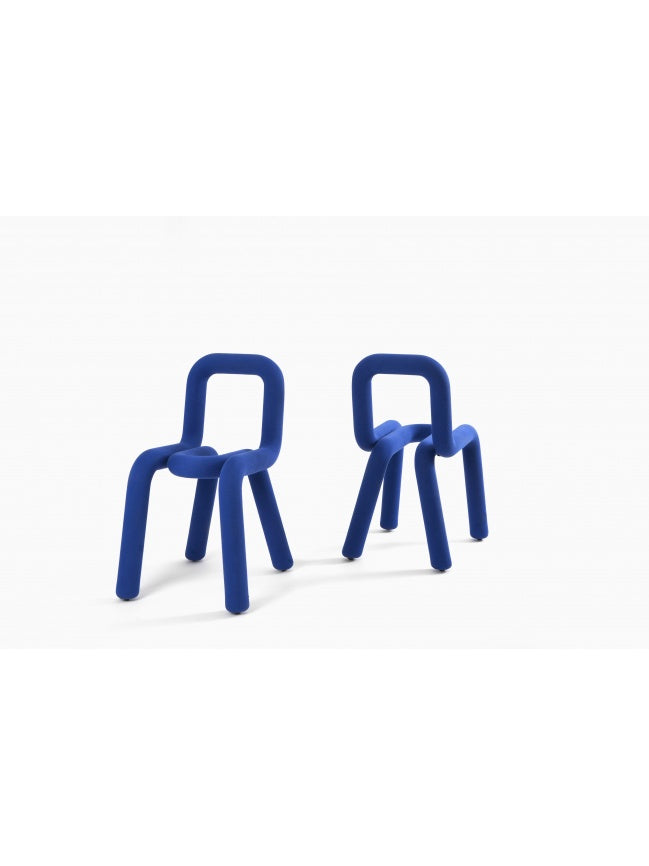 Moustache Bold Chair, a vibrant royal blue contemporary chair featuring a sculptural tubular metal frame entirely wrapped in a plush, soft fabric upholstery, creating a distinctive rounded, minimalist silhouette.