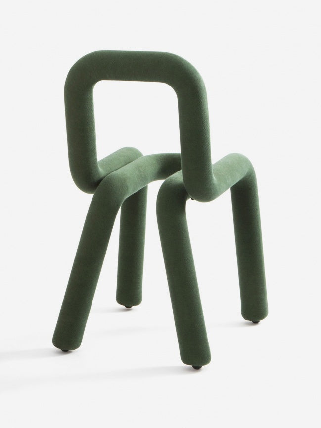 Moustache Bold Chair, a striking forest green contemporary chair featuring a continuous, curvilinear tubular metal frame fully upholstered in a soft, textured textile. Its playful, sculptural design forms a padded seat, backrest, and legs from a single, seamless loop, embodying avant-garde modern furniture. Ideal as a statement dining chair, unique accent chair for a living room, or art furniture piece in a creative space.