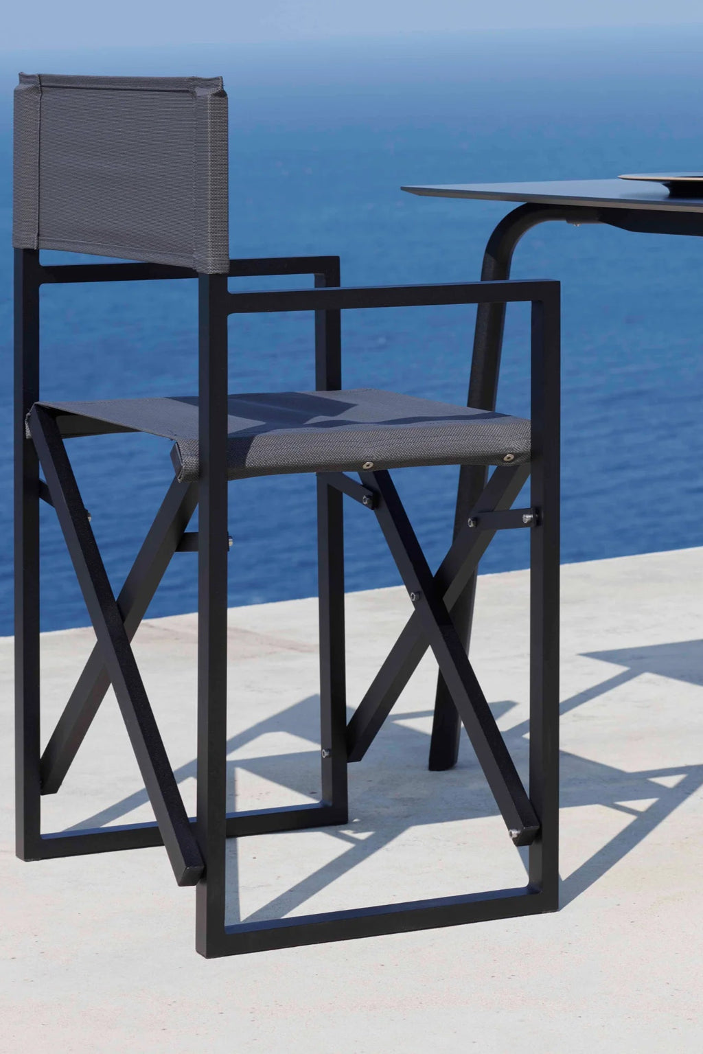 Gandia Blasco Clack! Outdoor Folding Chair, a sleek modern minimalist outdoor chair featuring a sturdy matte black powder-coated aluminum frame with clean rectangular lines and X-shaped cross-bracing.