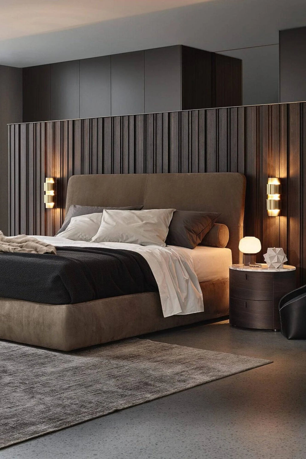 CTO Lighting Ring Wall Lamp - Short, a sleek modern wall sconce crafted from brushed brass metal, featuring three stacked cylindrical rings that cast a warm up and down light. This contemporary gold wall light is perfect for luxury bedroom accents, sophisticated living rooms, or elegant hallway lighting in modern minimalist interiors.