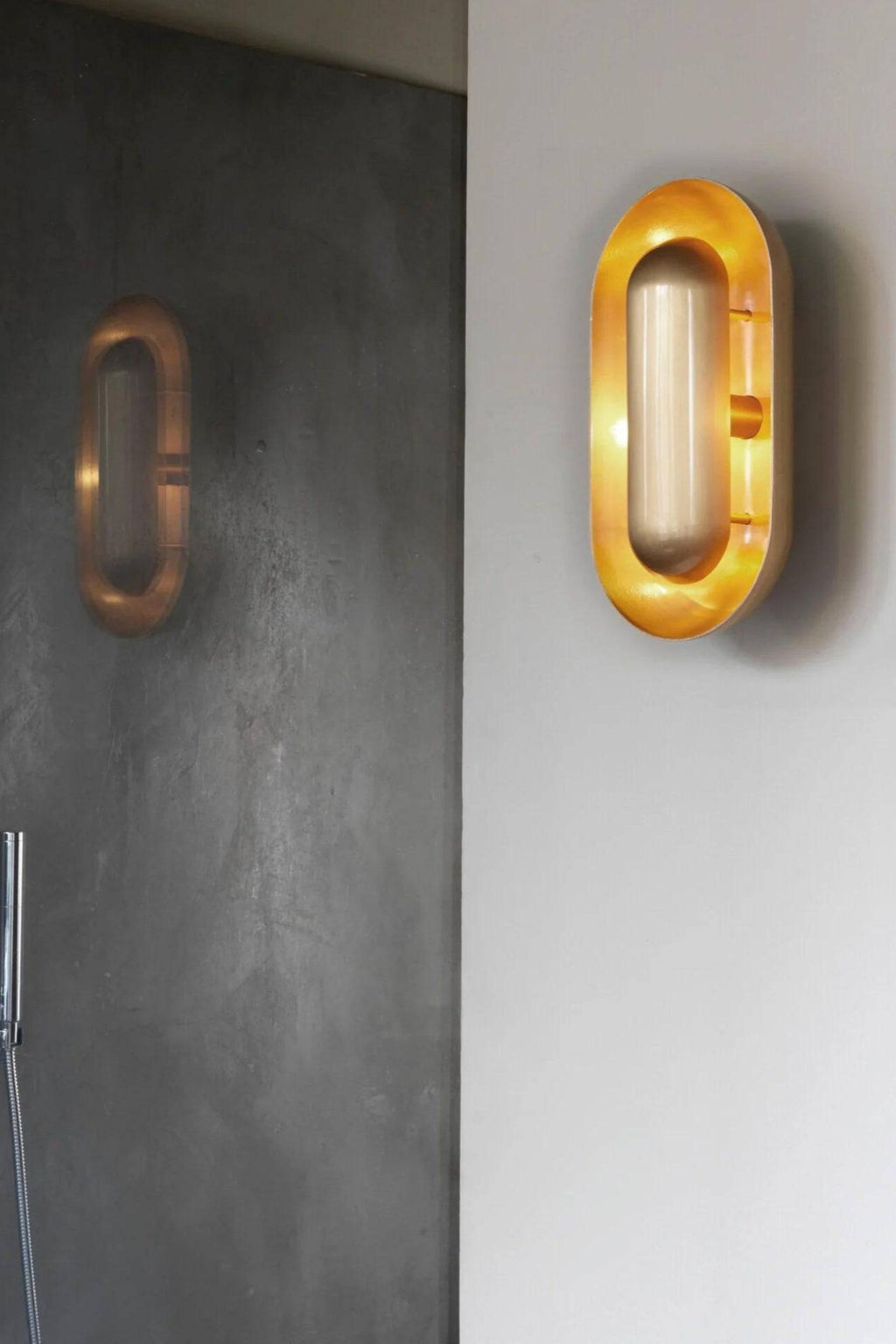 CTO Lighting Capsule Wall Lamp, a sleek modern wall light featuring a polished brass capsule-shaped frame with a warm gold finish, encasing a soft opal glass cylindrical diffuser that emits a gentle glow. This contemporary brass sconce is ideal for luxury bathroom lighting, minimalist bedrooms, or elegant hallway accents.