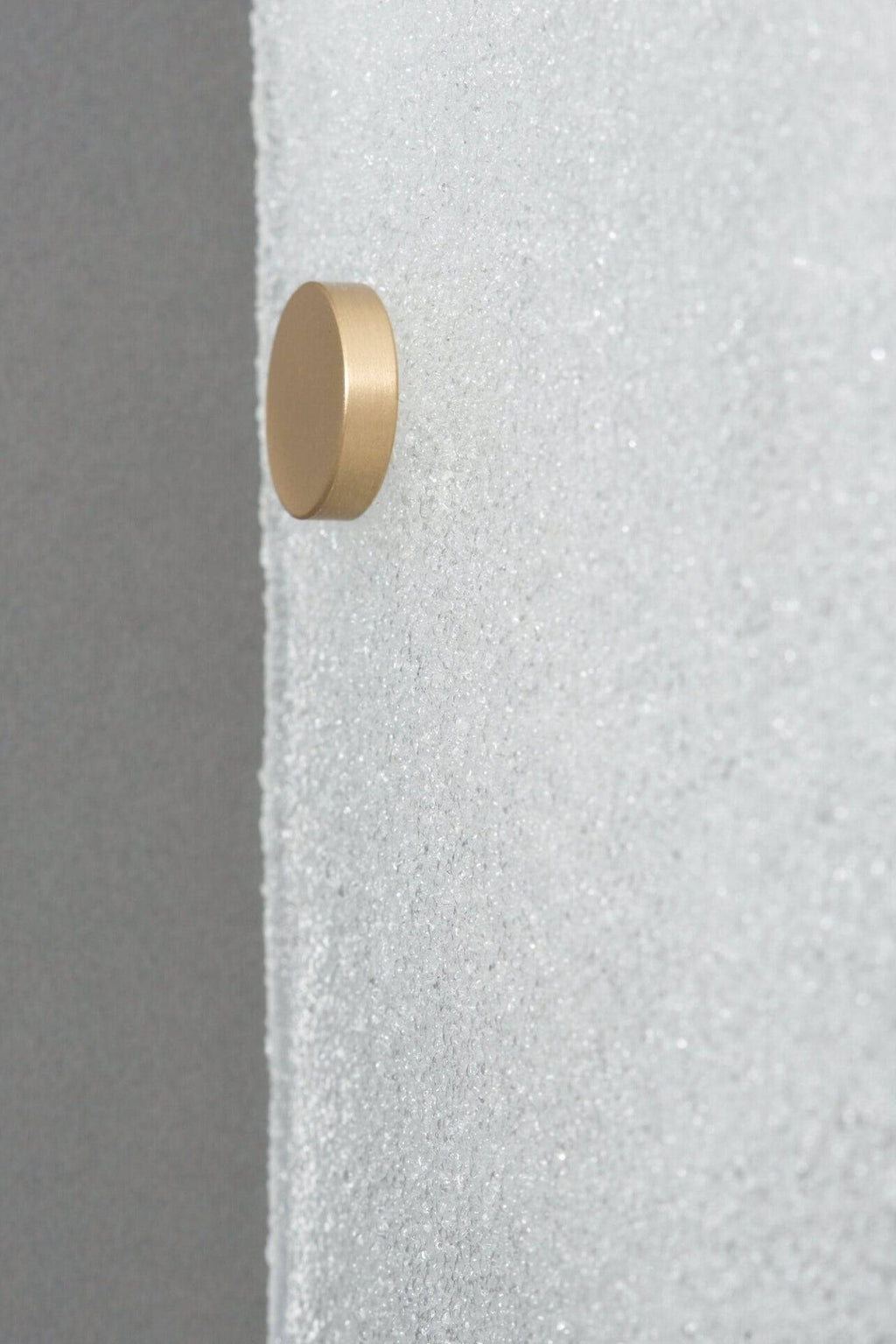 CTO Lighting Whistler Wall Lamp, a sleek modern minimalist wall light featuring a perfectly round, cylindrical disc crafted from luxurious brushed brass, offering a warm metallic glow. This contemporary brass wall sconce is ideal for creating sophisticated accent lighting in luxury living rooms, elegant bedrooms, or stylish entryways.