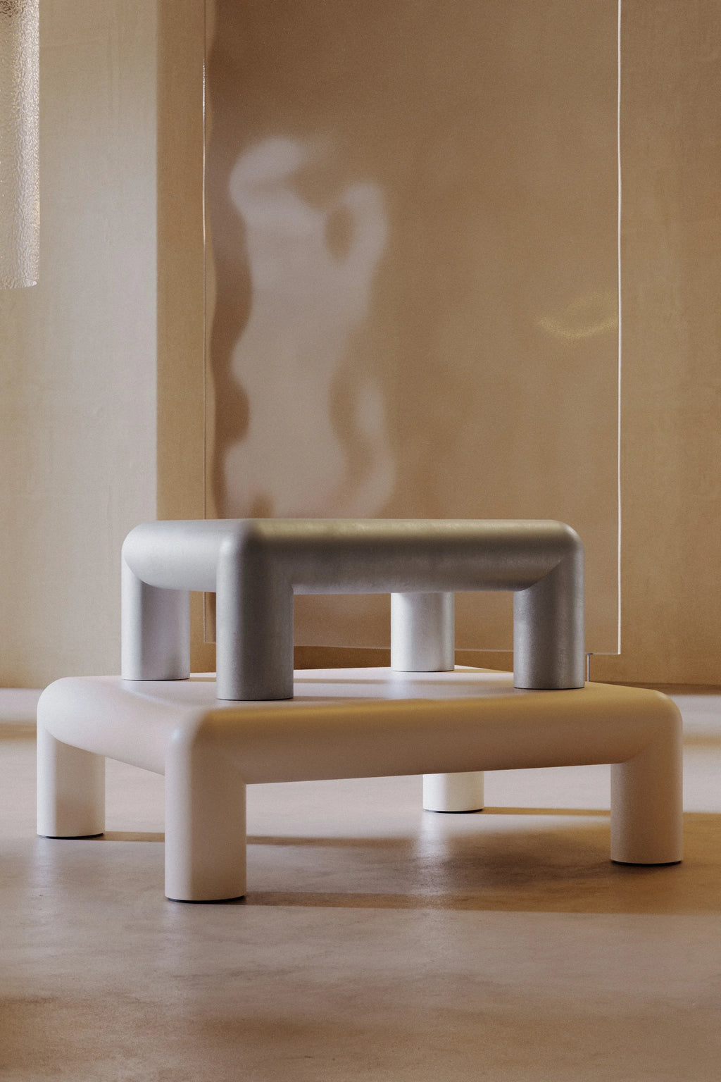 Modern, minimalist Formarkivet coffee tables with a neutral color palette in a softly lit room.