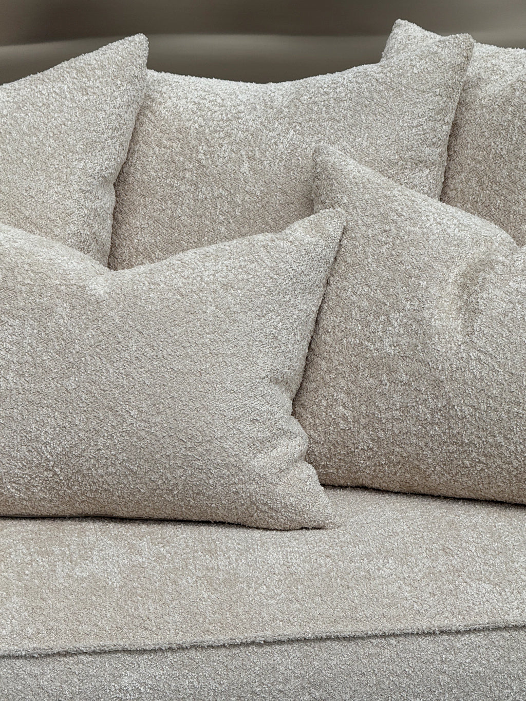 Tinted Objects Cornell Sofa, a plush organic modern sofa upholstered in a luxurious light beige bouclé fabric with a soft, highly textured finish and deep, inviting cushions. This contemporary bouclé couch is perfect for creating a cozy living room or Scandinavian-inspired lounge space.