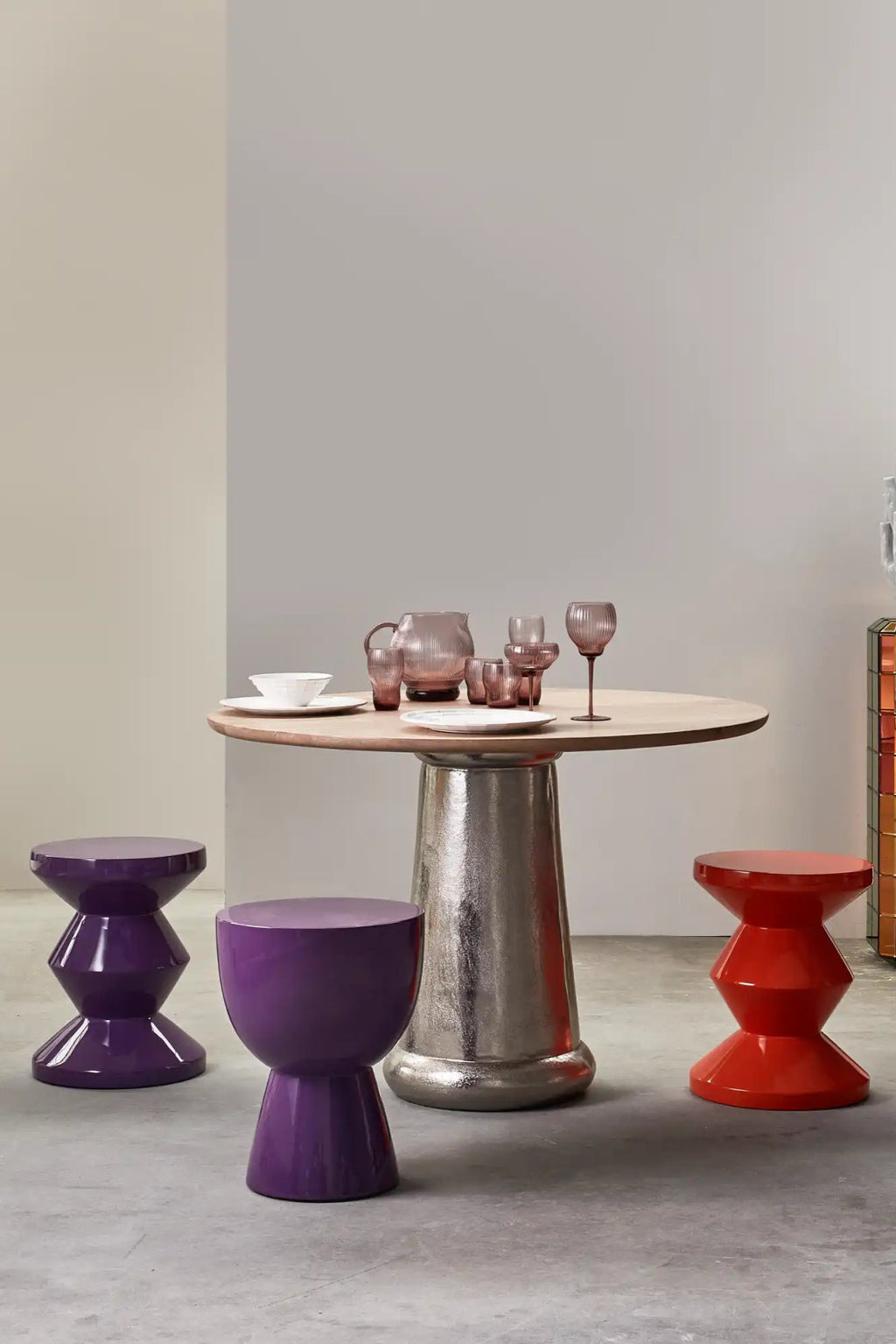 POLSPOTTEN Tip Tap Stool, a vibrant collection of contemporary lacquered fiberglass stools in glossy deep purple and bright red finishes, showcasing two distinct geometric shapes: a stacked hourglass design and a drum-like silhouette with a tapered base. These playful and sculptural accent stools are perfect for adding a pop of color to modern living rooms, bedrooms, or creative spaces.