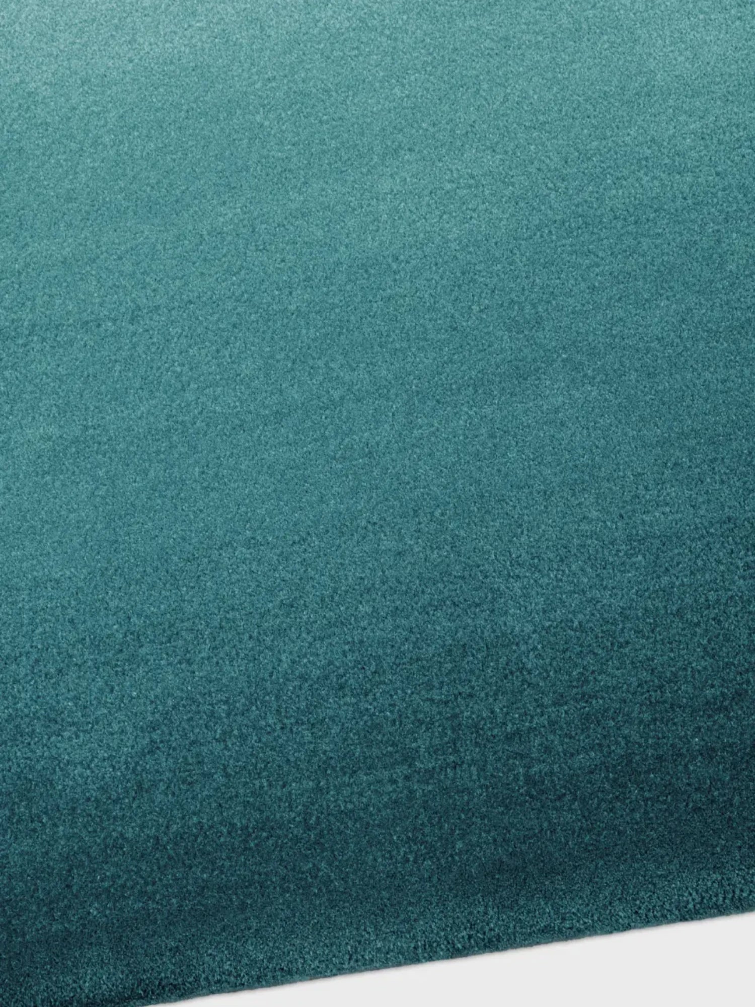 alp_ Degradé Double Rug, a luxurious contemporary area rug featuring a striking ombré teal color gradient that transitions from a lighter aqua to a deep, rich turquoise.