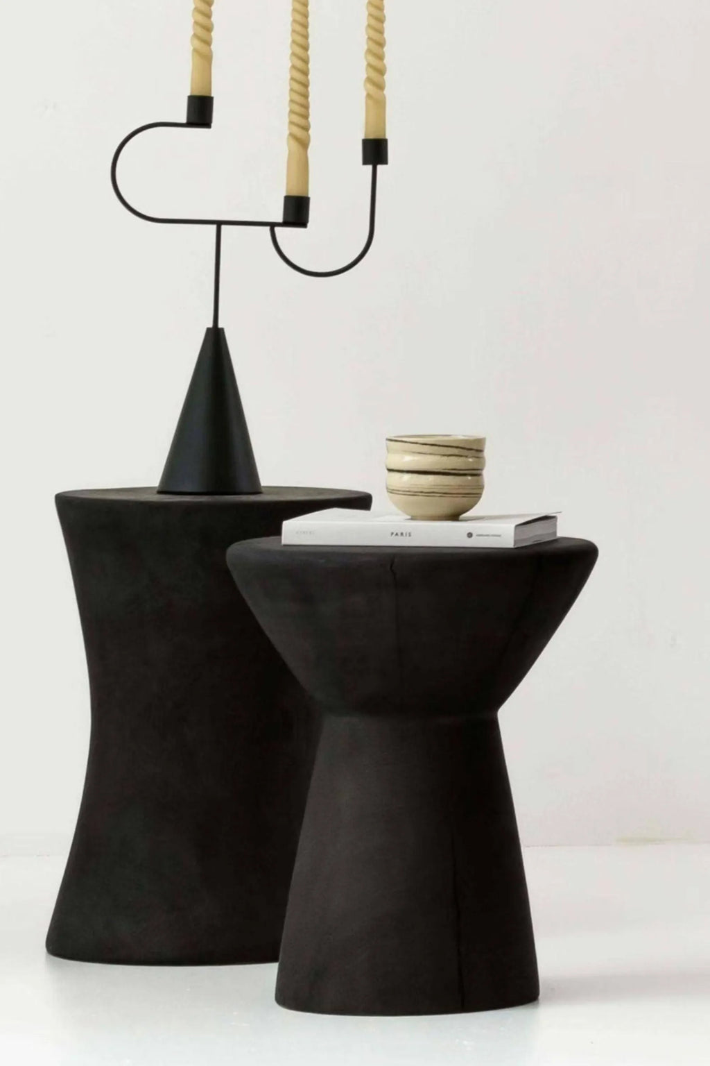 Detjer Stool S.A.S. 006, a sculptural organic modern stool crafted from matte black solid wood with a textured finish and a distinctive hourglass silhouette.