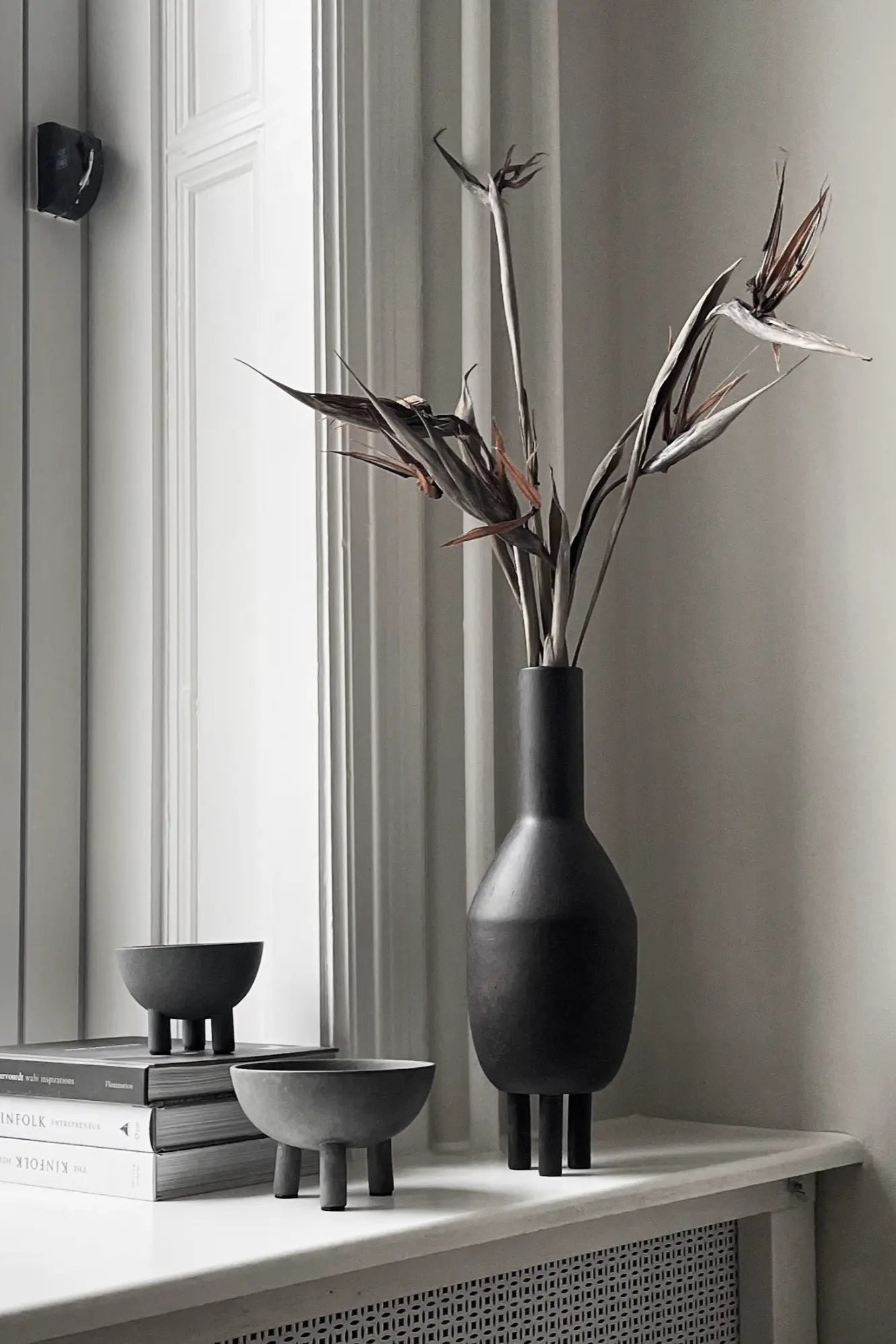 ###
A sleek and modern slim duck vase in white ceramic finish