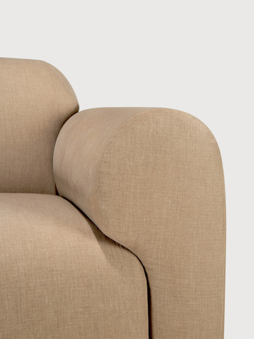 Ethnicraft Bulky Modular Sofa detail, focusing on the seamless curve of the armrest and backrest, upholstered in a sophisticated, durable beige fabric, against a light background.