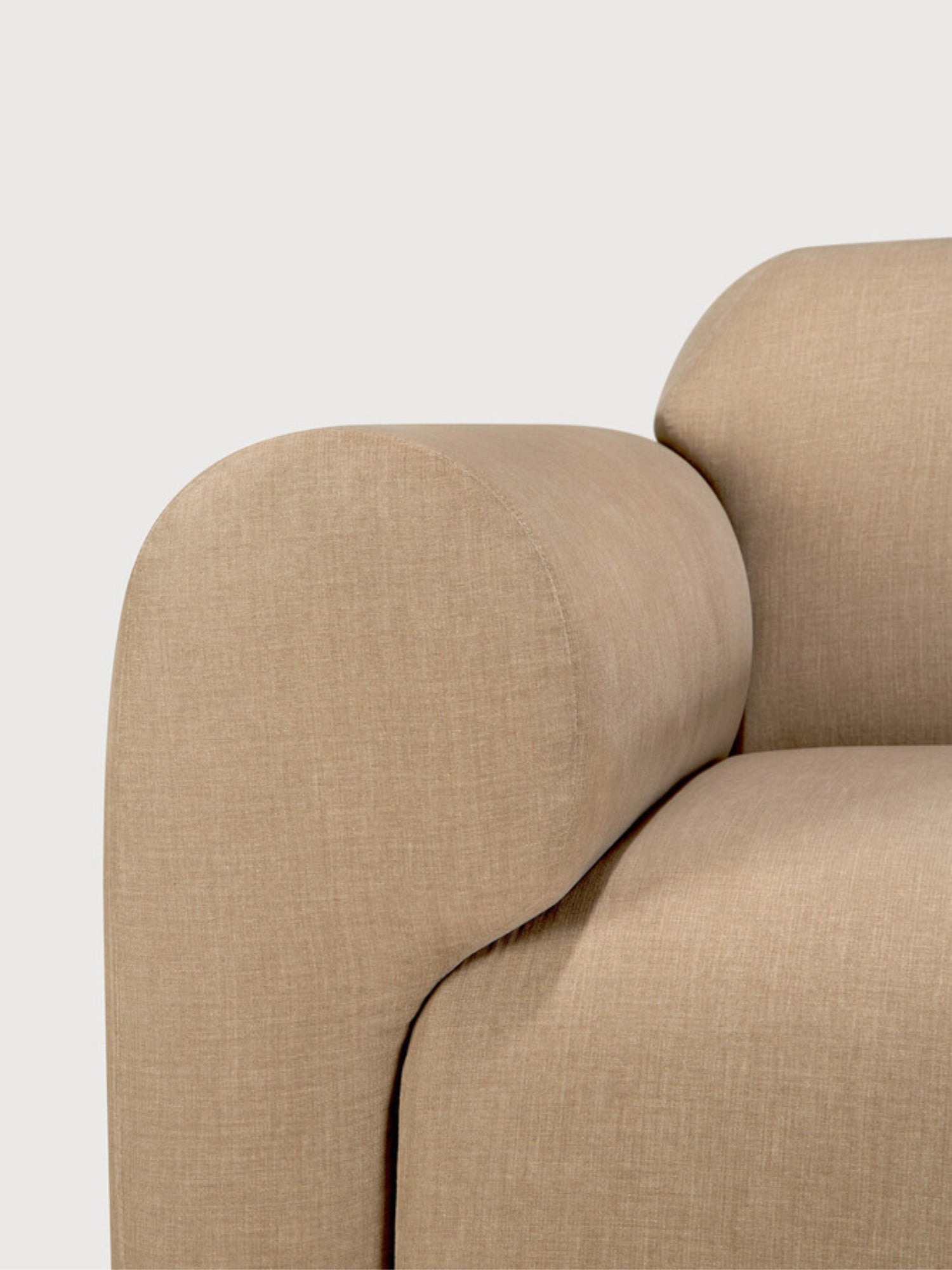 Ethnicraft Bulky Modular Sofa, a detailed close-up of the right armrest on the end seater module, showcasing the smooth, rounded contour and the high-quality light brown textured fabric.