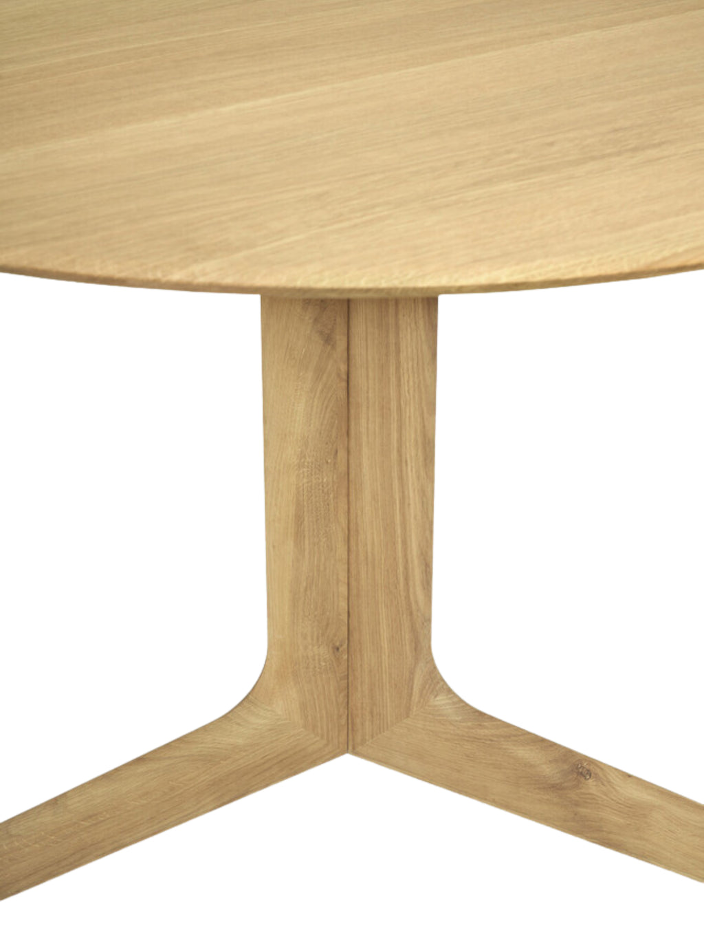 Ethnicraft Corto Dining Table, a round oak table, presenting a full view of the light brown wooden tabletop and the unique, sculptural base, highlighting its contemporary design on a white background.