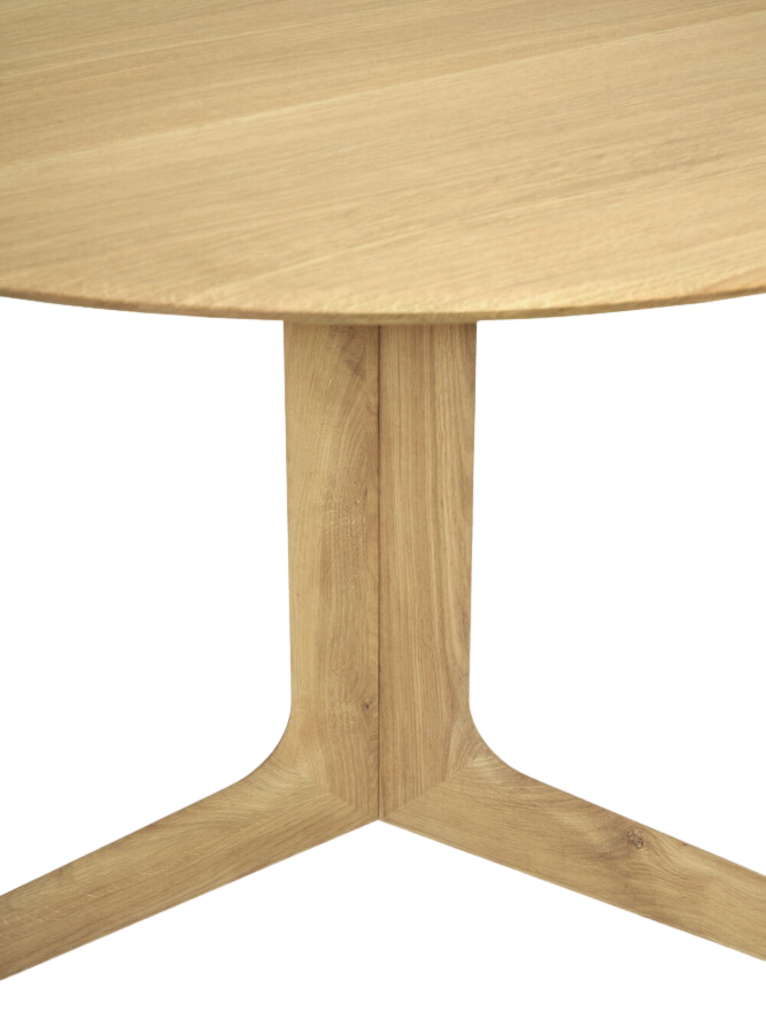 Ethnicraft Corto Dining Table, a round oak table, presenting a full view of the light brown wooden tabletop and the unique, sculptural base, highlighting its contemporary design on a white background.