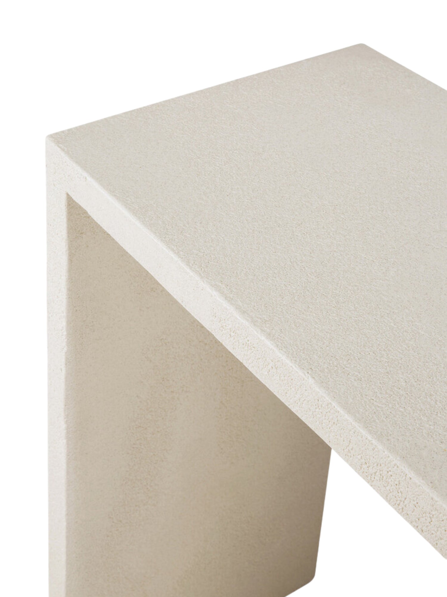 Ethnicraft Elements Console, showcasing a detailed close-up of its top surface and side. The premium light beige microcement material reveals a fine, granular texture, highlighting the console's craftsmanship on a white background.