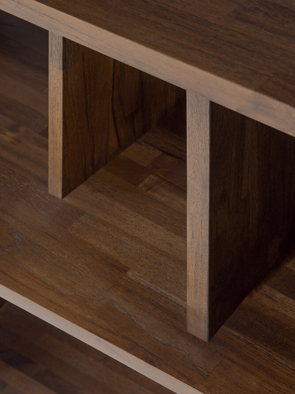 Ethnicraft Irregular Rack, a detailed view emphasizing the premium solid teak wood's natural texture and deep brown color, with a focus on the precise joinery and the elegant, irregular spacing of the shelves, presented on a white backdrop.