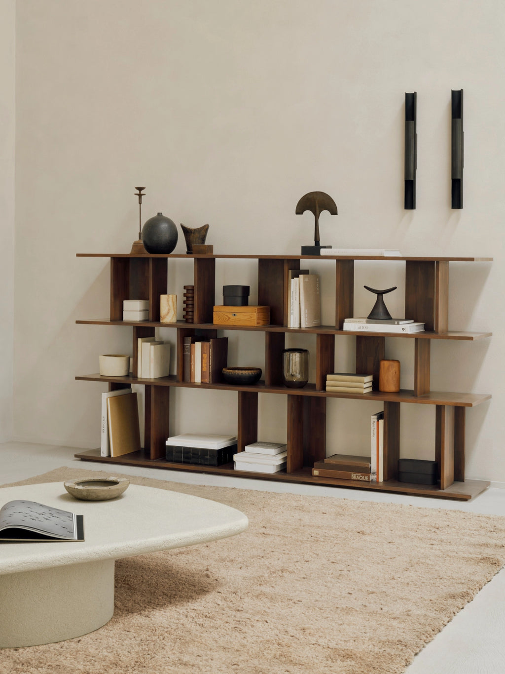 Ethnicraft Irregular Rack in Teak Brown, a versatile wooden shelving unit showcasing various home decor items, books, and plants in a beautifully styled modern interior.