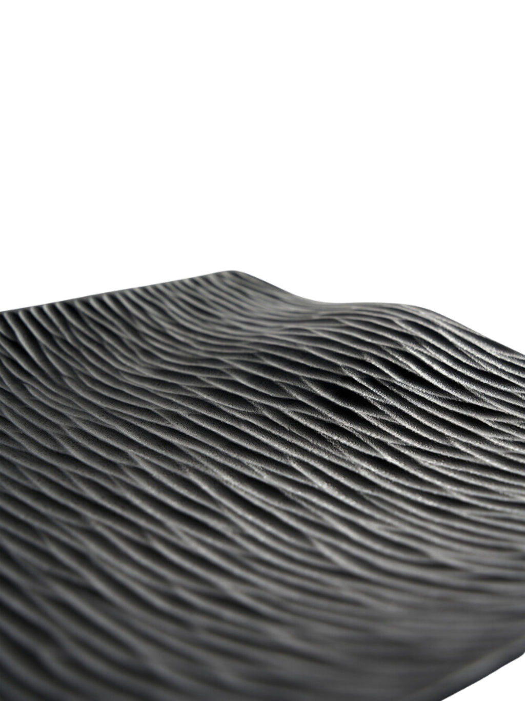 Ethnicraft Japan Board, a detailed close-up of the black serving board's surface, showcasing its intricate, wave-like textured pattern. The dark, matte finish and organic ripples create a sophisticated and tactile design, presented on a white background.
