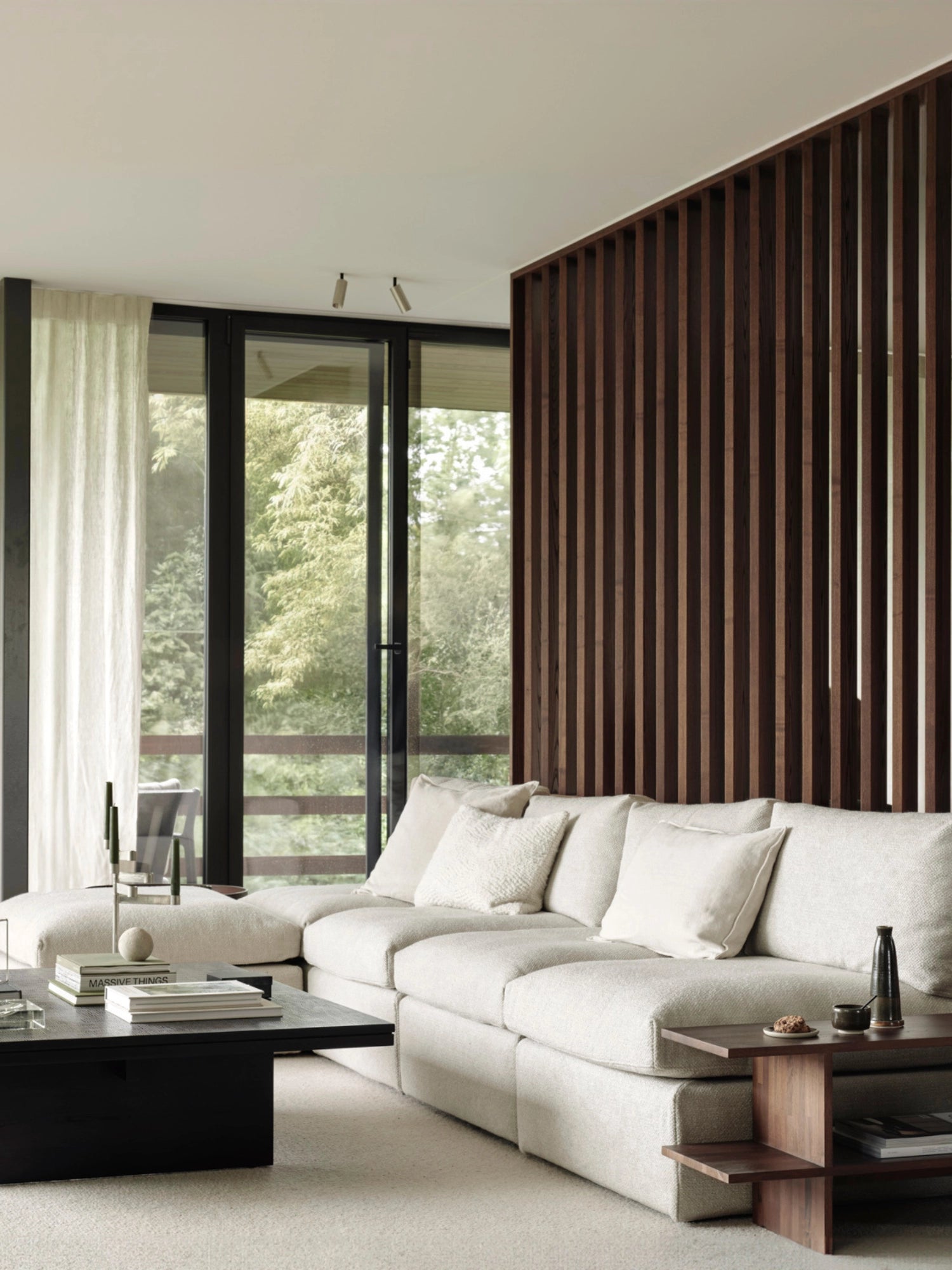 Ethnicraft Mellow Modular Sofa, a large, elegant sectional in a light cream, textured fabric, arranged in a spacious living room. The deep cushions and clean lines provide a luxurious, comfortable feel, surrounded by modern decor and natural light.