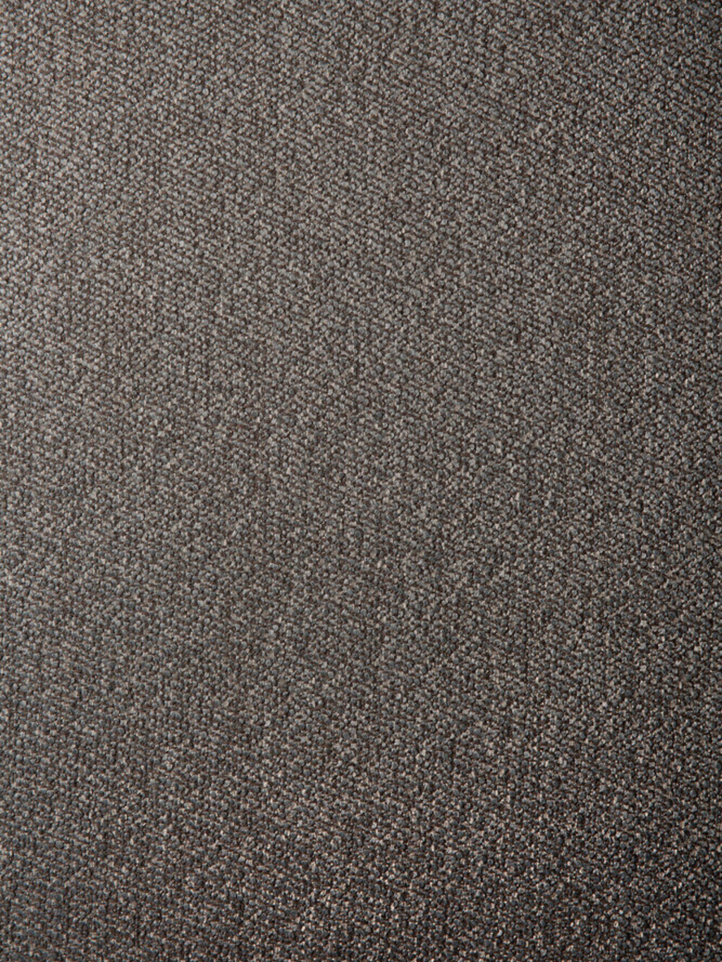 Ethnicraft Mellow Modular Sofa 90° Square Corner, close-up of the fabric texture. The premium dark gray, woven material shows a subtle, intricate pattern, highlighting its durable and luxurious feel.
