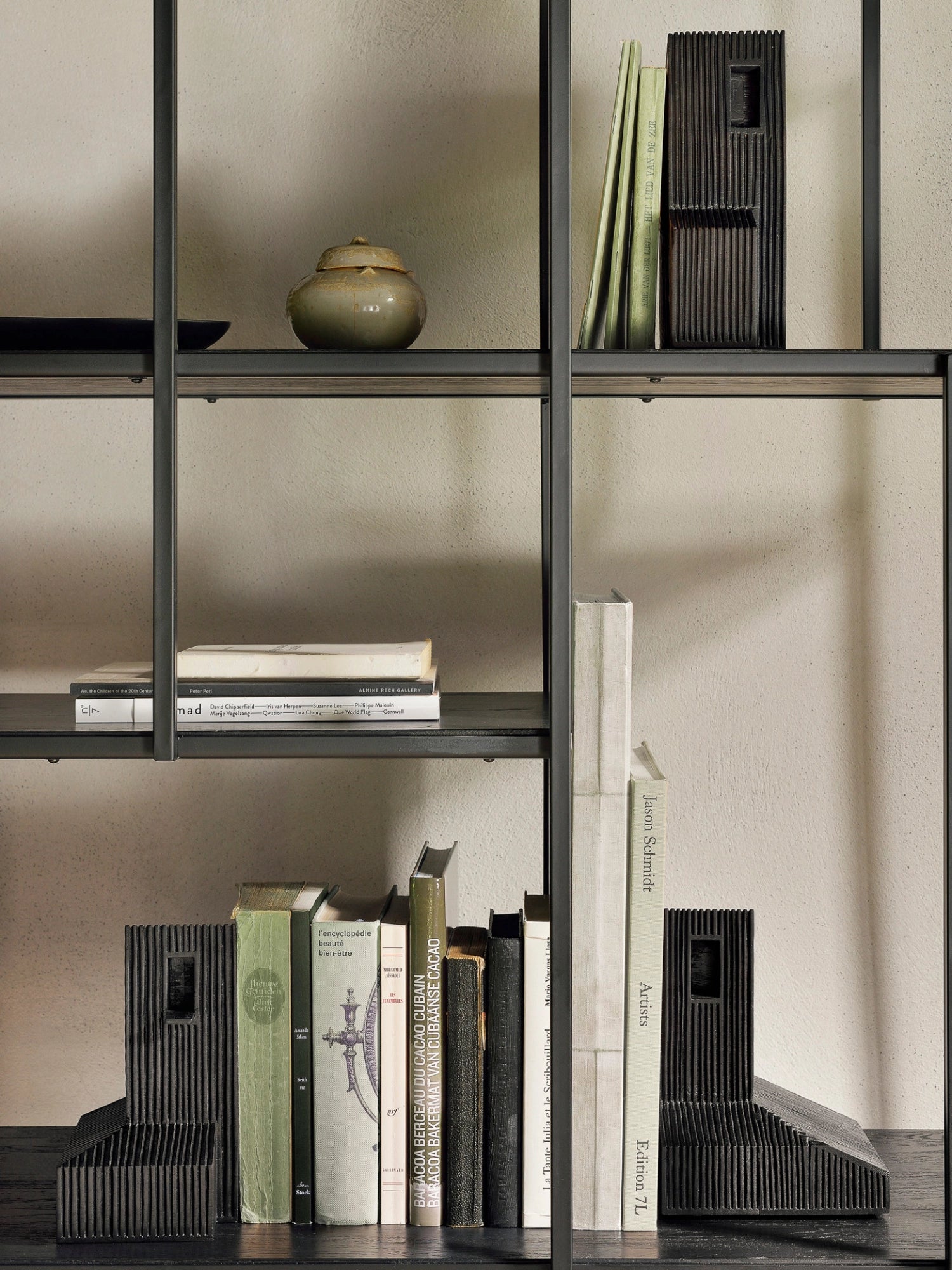 Ethnicraft Modern Farmhouse Object, a unique black wooden decorative piece with a textured, ridged surface, displayed elegantly on a dark bookshelf alongside books and a ceramic pot, enhancing a sophisticated living space.