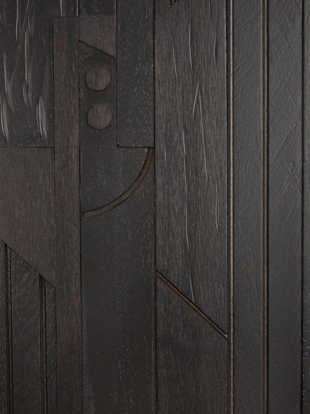 Ethnicraft Mosaic Sideboard in Teak Off-Black, a close-up detail of the dark wood surface, showcasing the unique carved geometric patterns and rich texture of the teak wood.