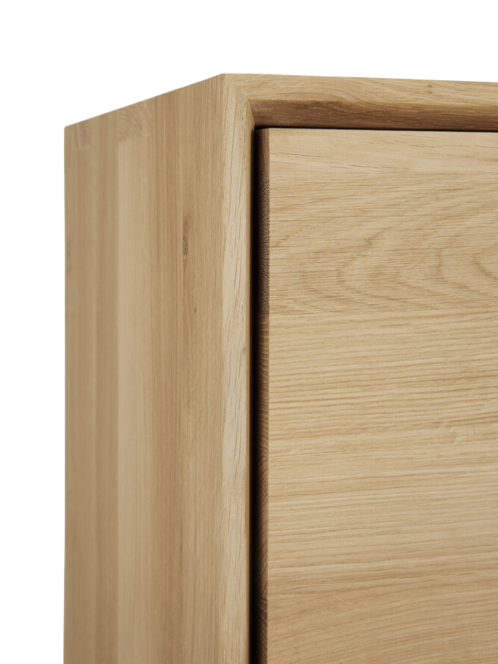 Ethnicraft Nordic Sideboard, a close-up detail of the corner and cabinet door edge, highlighting the smooth, natural grain and premium craftsmanship of the light oak wood.