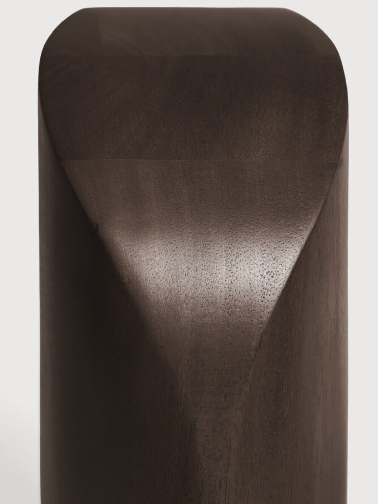 Ethnicraft PI Bookends in Mahogany Dark Brown, a close-up detail of the smooth, dark wood surface and the precise, geometric carving that defines its modern, sculptural form, on a white background.