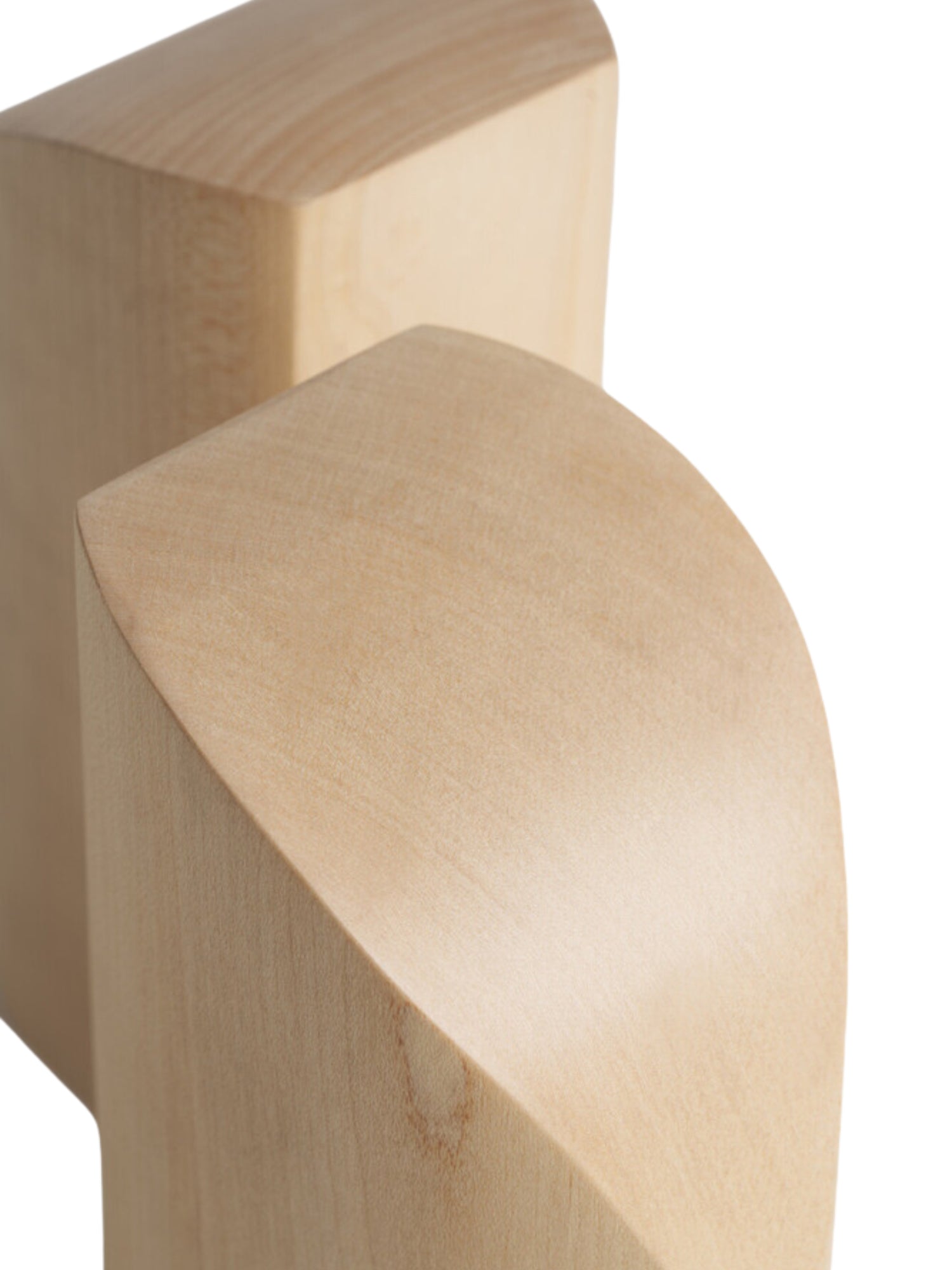 Ethnicraft PI Bookends, a close-up detail of the premium sycamore wooden bookends, highlighting the smooth, natural wood grain and the elegant, precise curvature of their design.