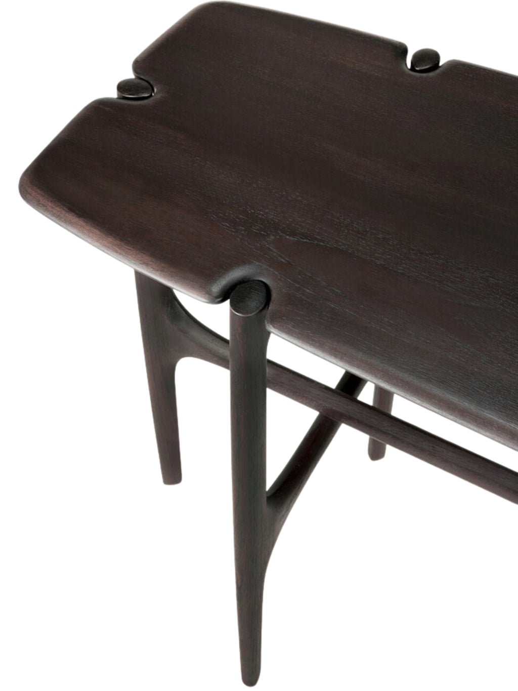 Ethnicraft PI Console in dark brown teak, a close-up detail shot highlighting the exquisite craftsmanship, showing the smooth, dark wood grain and the unique, curved leg joint design.