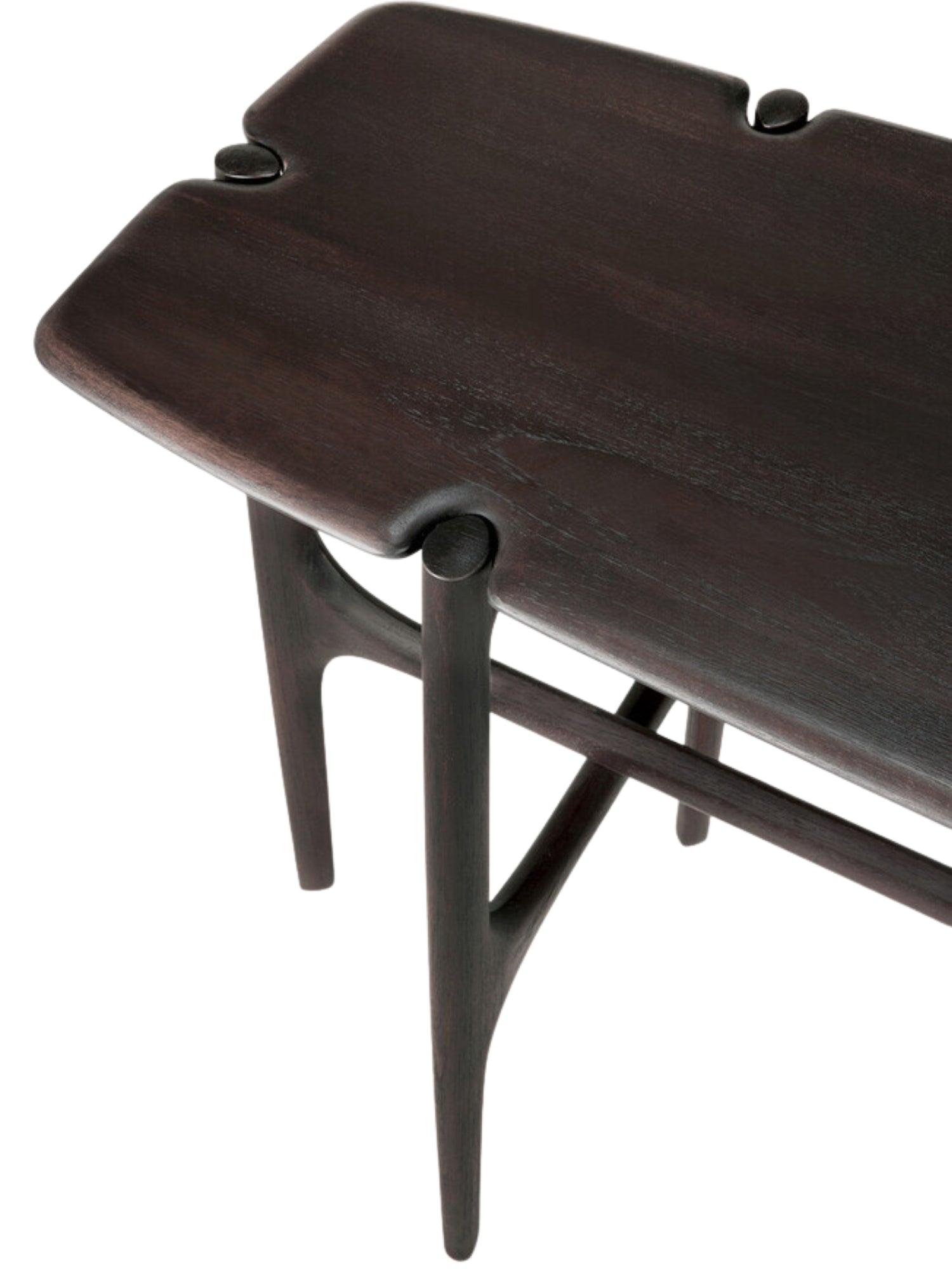 Ethnicraft PI Console in dark brown teak, a close-up detail shot highlighting the exquisite craftsmanship, showing the smooth, dark wood grain and the unique, curved leg joint design.