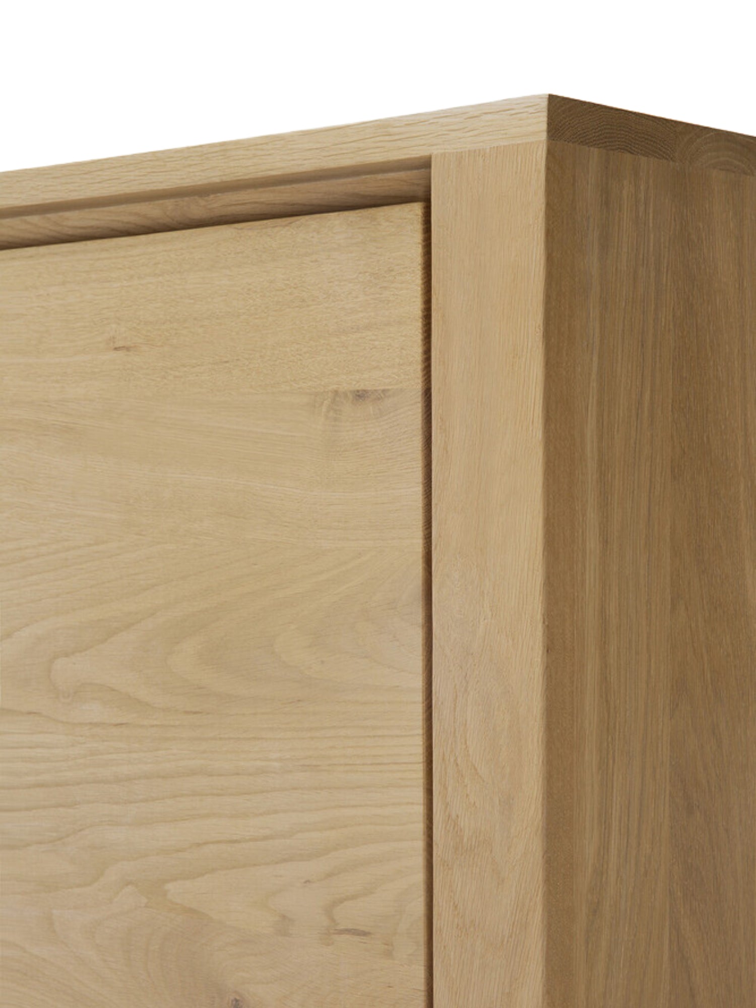 Ethnicraft Shadow Dresser in natural oak, showing a detailed view of the top corner with its clean lines and subtle wood grain texture, emphasizing the premium craftsmanship.