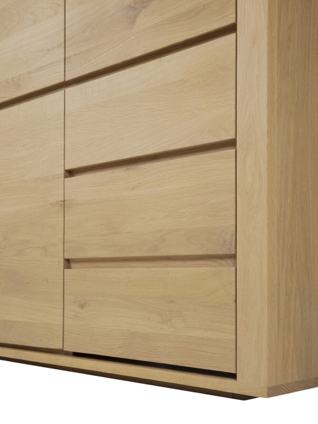 Ethnicraft Shadow Dresser in natural oak, a close-up detail of the lower drawers, highlighting the flush, handle-less design and the beautiful, natural wood grain texture.