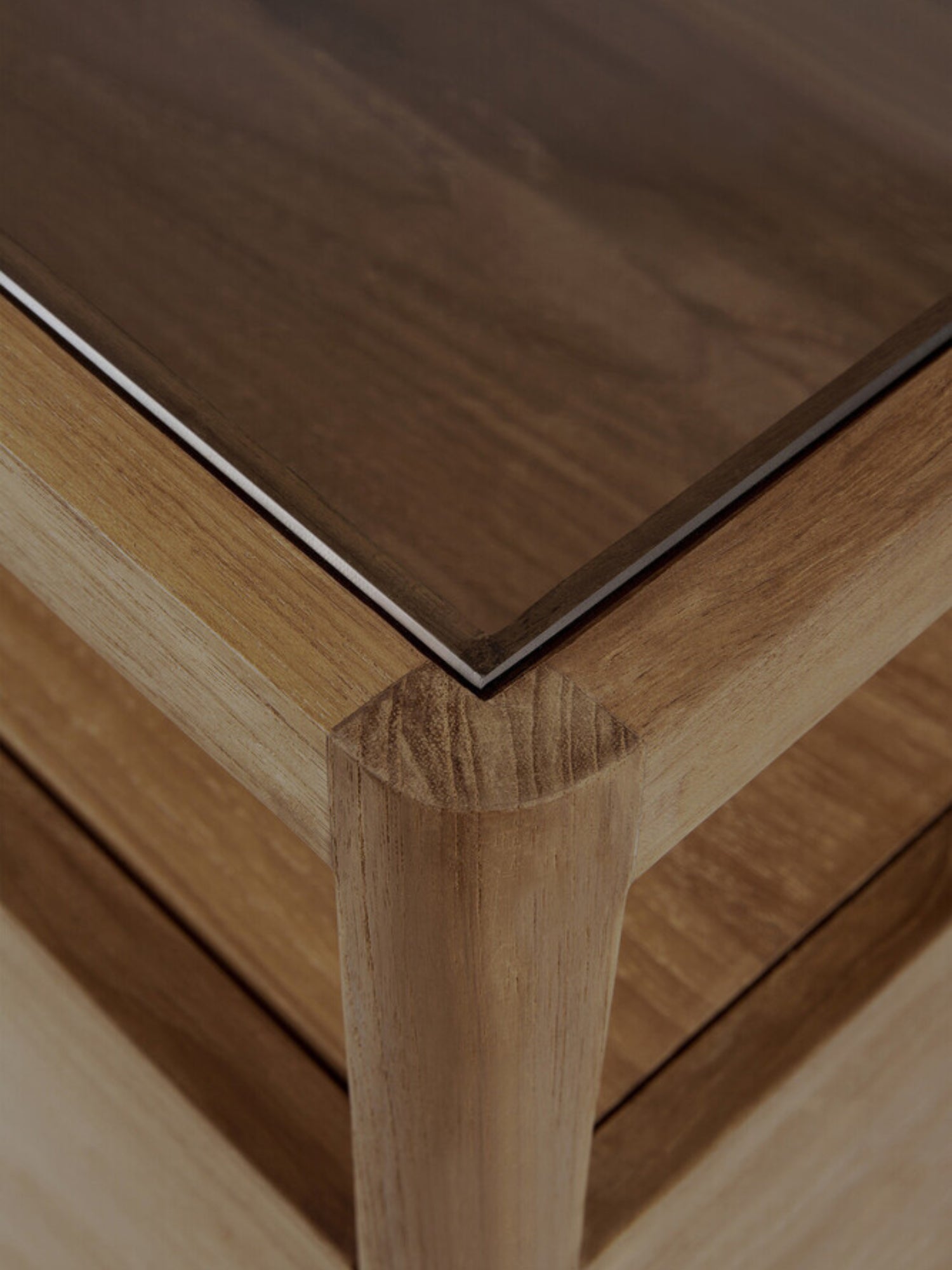 Ethnicraft Spindle Dresser in light oak, highlighting a corner detail with a smooth glass top and sturdy, rounded wooden legs, providing a modern, elegant aesthetic.