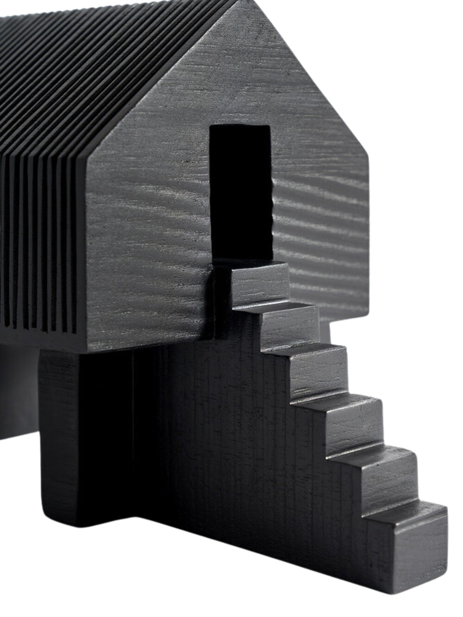 Ethnicraft Stilt House Object. Close-up detail of the dark black wooden house sculpture, highlighting the intricate ribbed texture on the roof and side, the small open doorway, and the ascending staircase, on a white background.