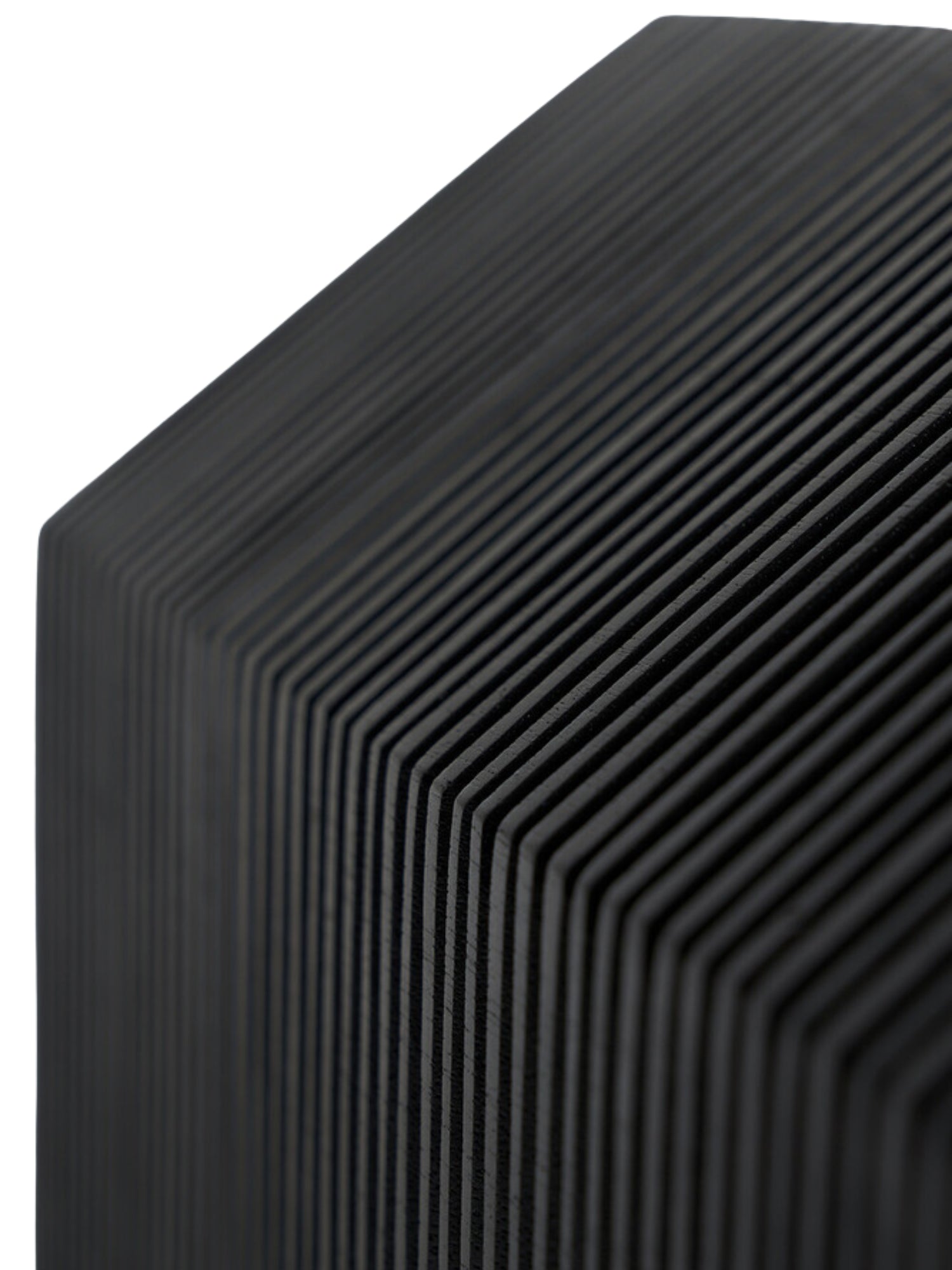 Ethnicraft Stilt House Object. Extreme close-up of the dark black wooden house sculpture, emphasizing the fine, parallel ribbed texture that creates a unique, modern pattern across its surface, against a white background.
