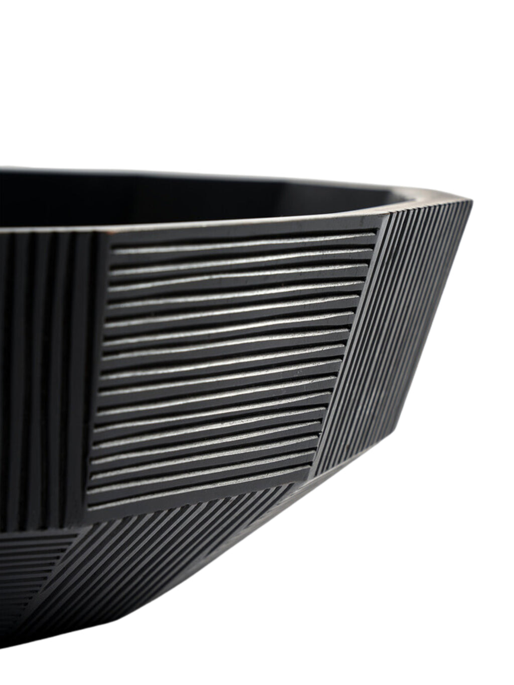 Ethnicraft Striped Bowl, a modern black ceramic bowl with a unique geometric design, featuring finely etched horizontal and diagonal stripes, showcasing its textured surface and contemporary aesthetic.