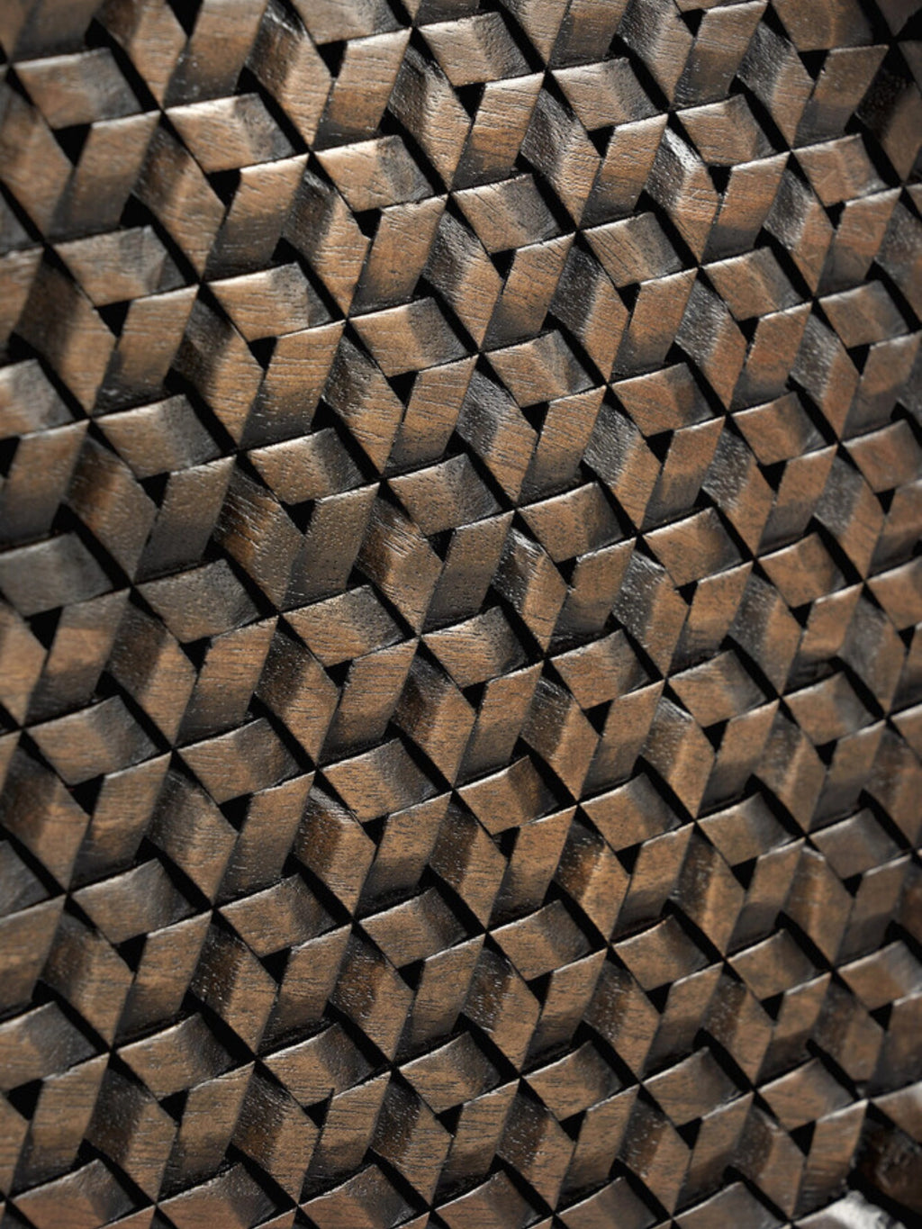 Ethnicraft Tampa Boards Set, a close-up detail of the rich dark brown wooden surface, showcasing the intricate, three-dimensional geometric woven pattern with varying shades and textures.